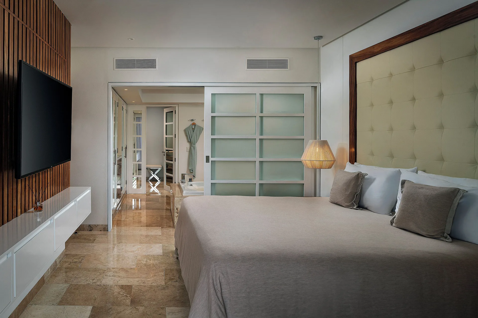 Bedroom with king bed in The Reserve Master Suite Nature View at Paradisus La Perla Riviera Maya.