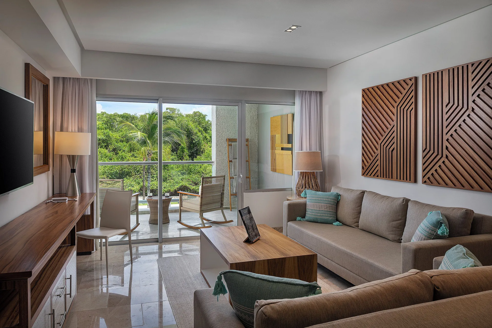 Living room and balcony view in The Reserve Master Suite Nature View at Paradisus La Perla Riviera Maya.