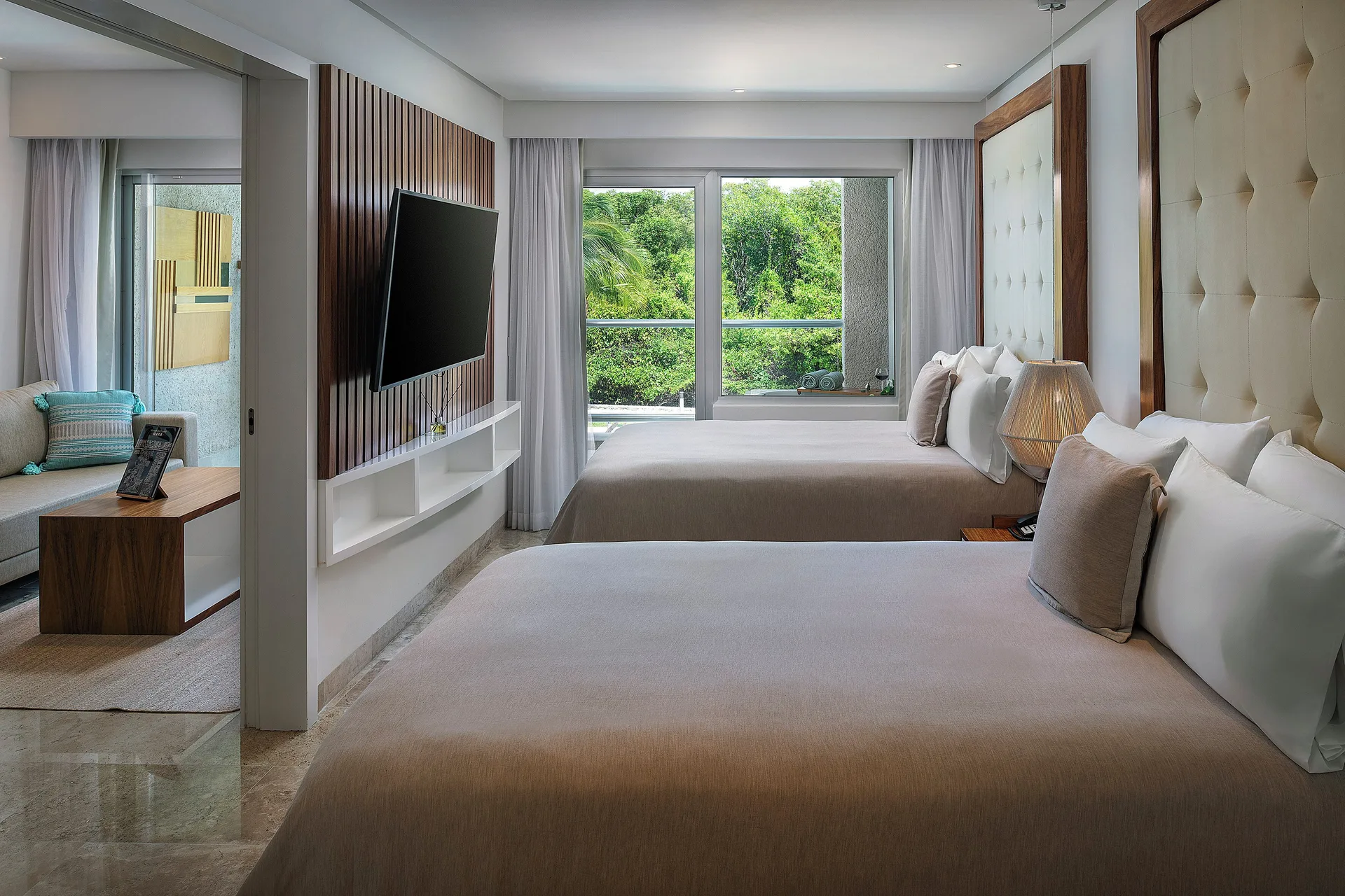 The Reserve Nature View suite bedroom with two beds at Paradisus La Perla Riviera Maya.