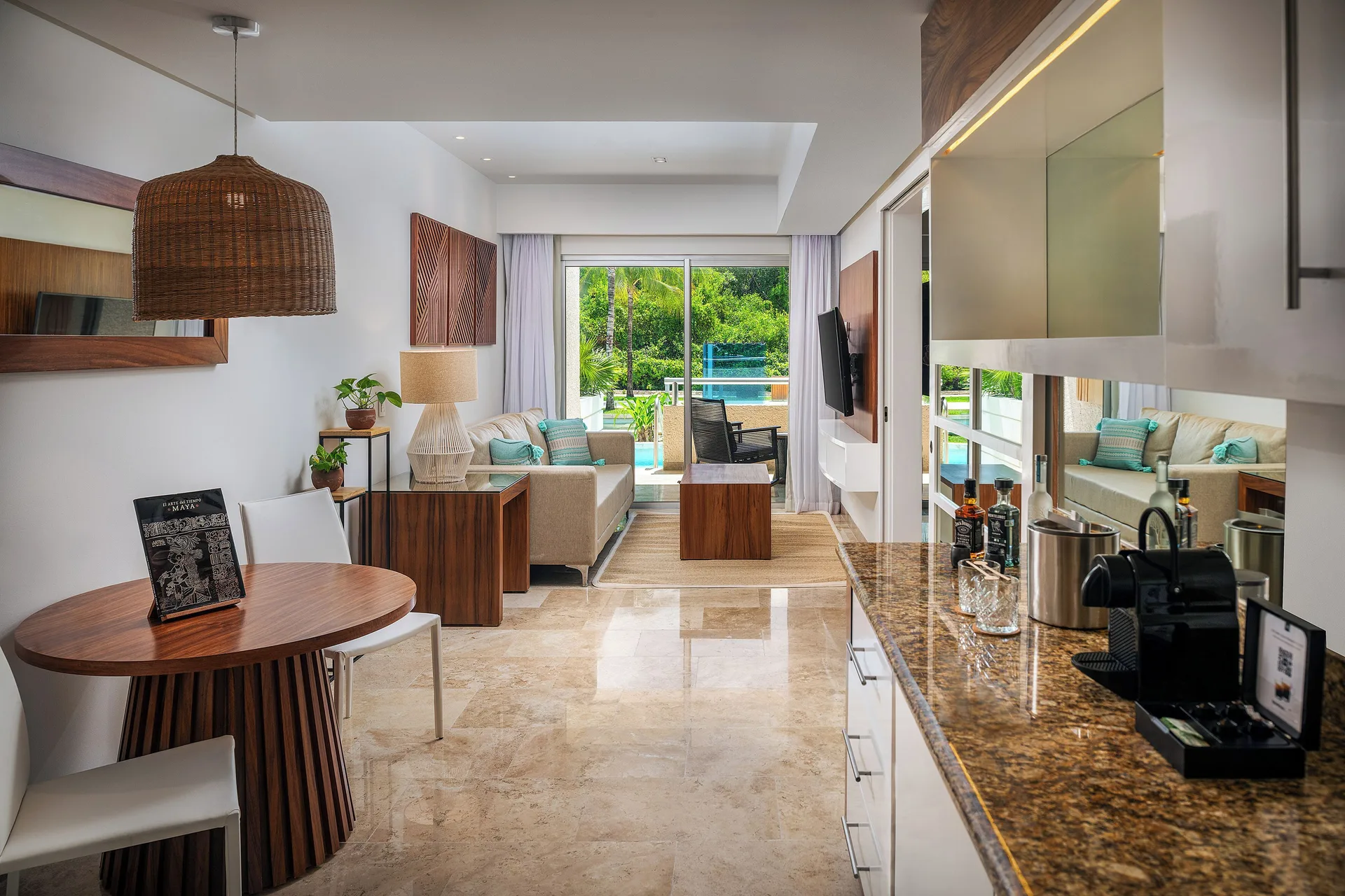 Reserve Suite Swim Up living area with dining table and refreshment counter at Paradisus La Perla Riviera Maya.