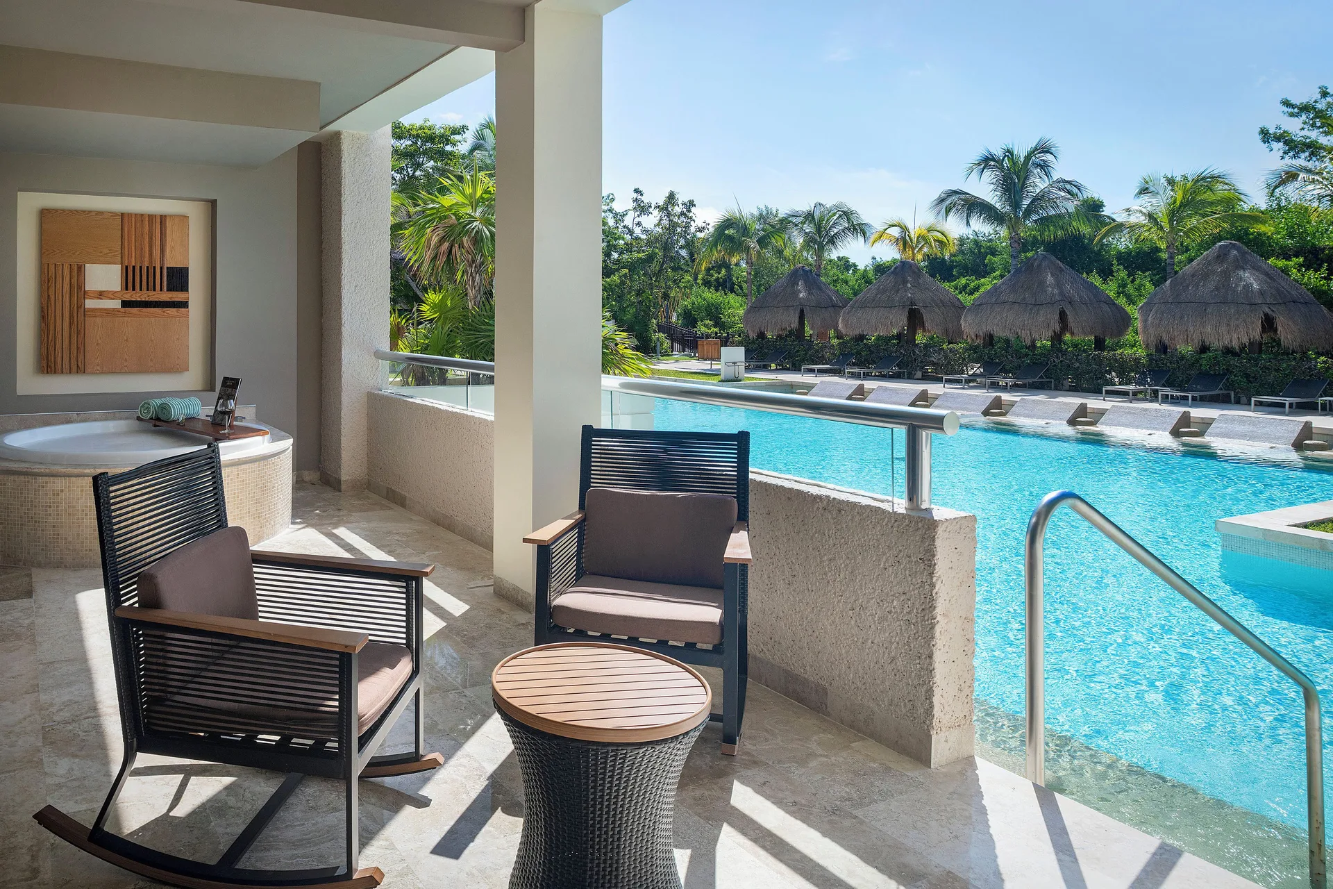 Reserve Suite Swim Up terrace with seating and pool stairs at Paradisus La Perla Riviera Maya.