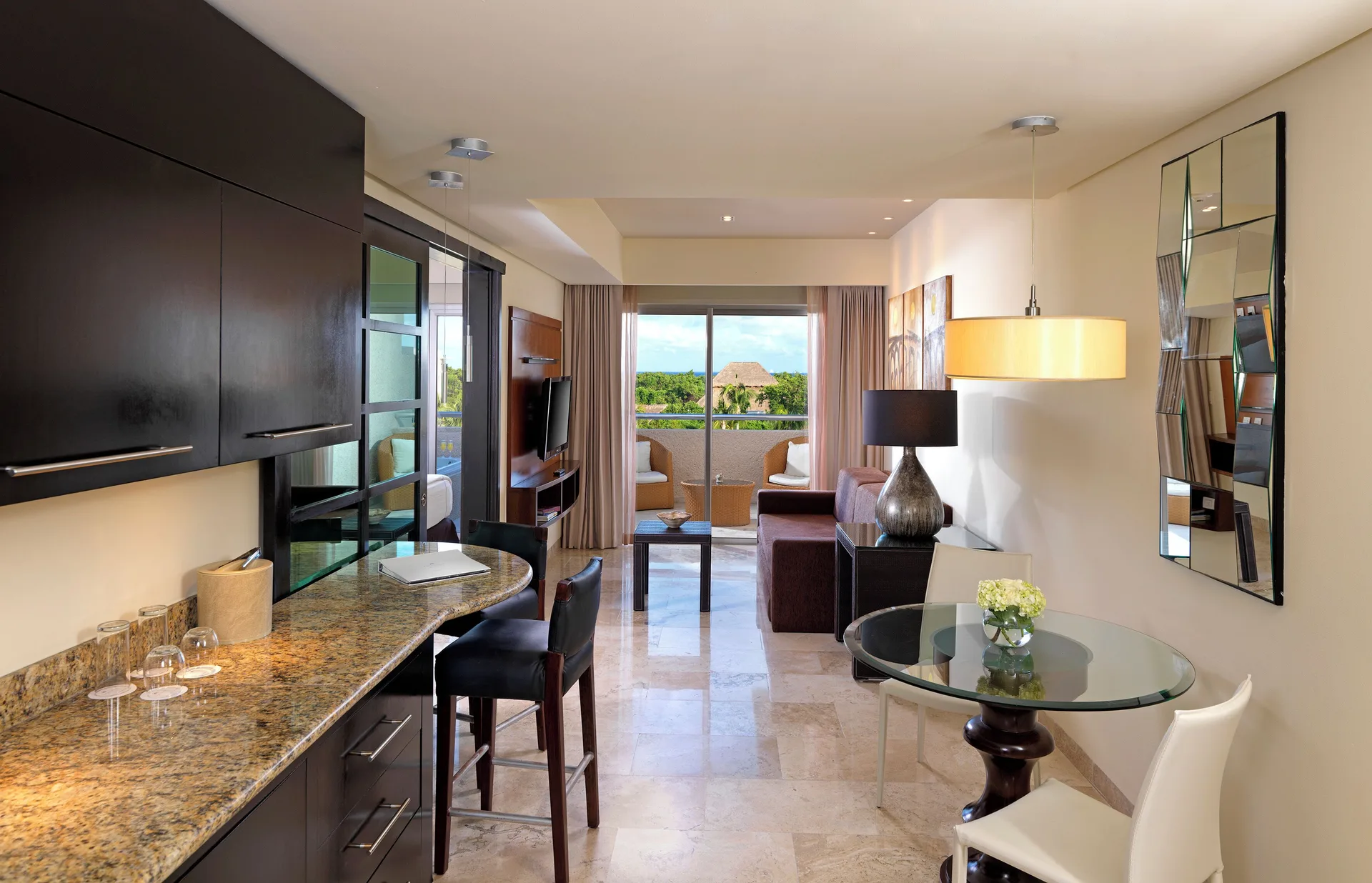 Two Bedrooms Master Suite living and dining area at Paradisus La Perla Riviera Maya with balcony beyond.