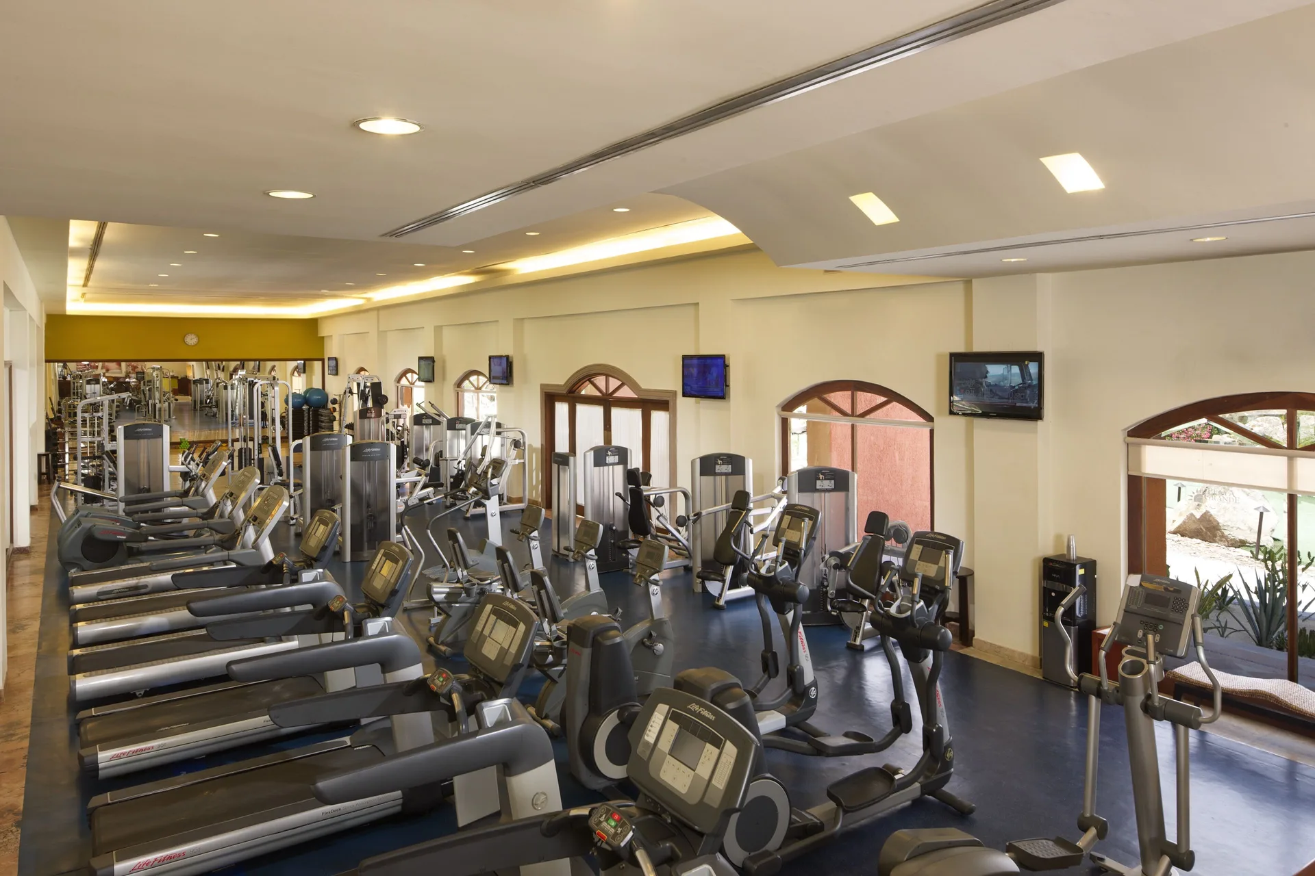 Rows of treadmills, bikes and machines in the gym at Playa Grande Resort & Grand Spa.