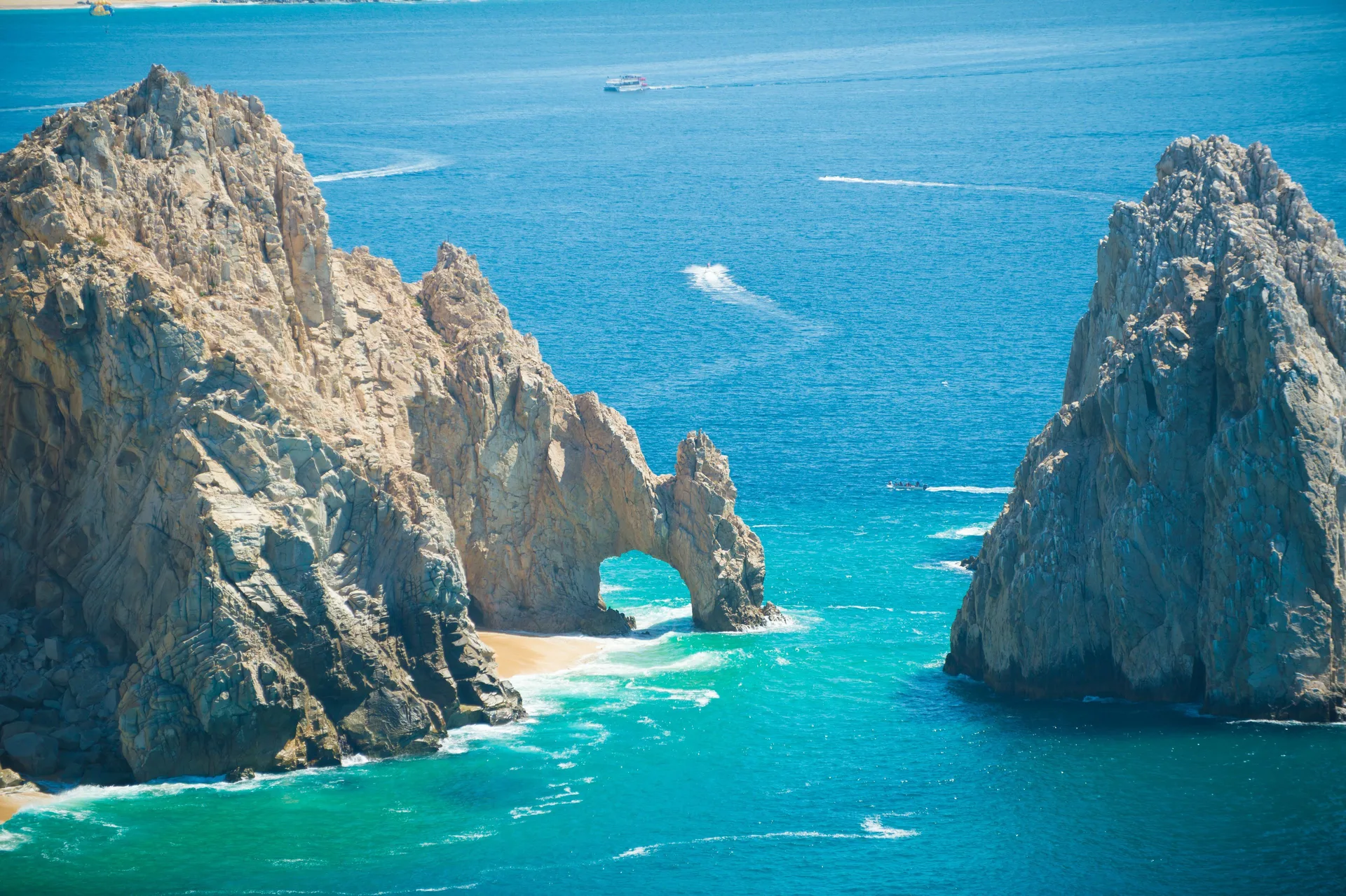 Rock arch and turquoise sea near Playa Grande Resort & Grand Spa in Cabo San Lucas.