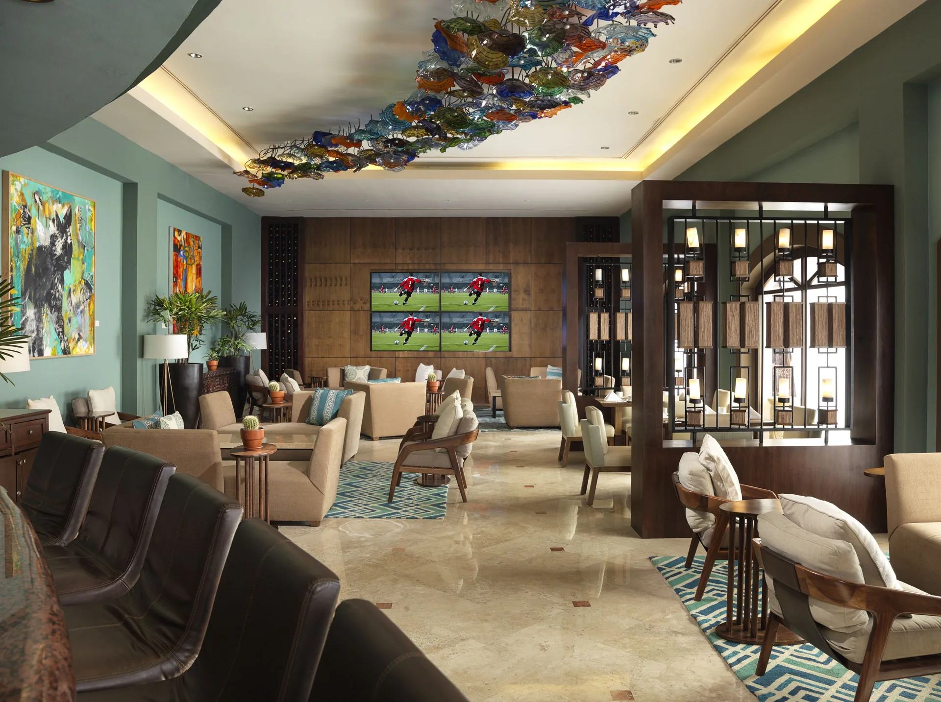 Sports lounge with TVs and seating at Playa Grande Resort & Grand Spa.