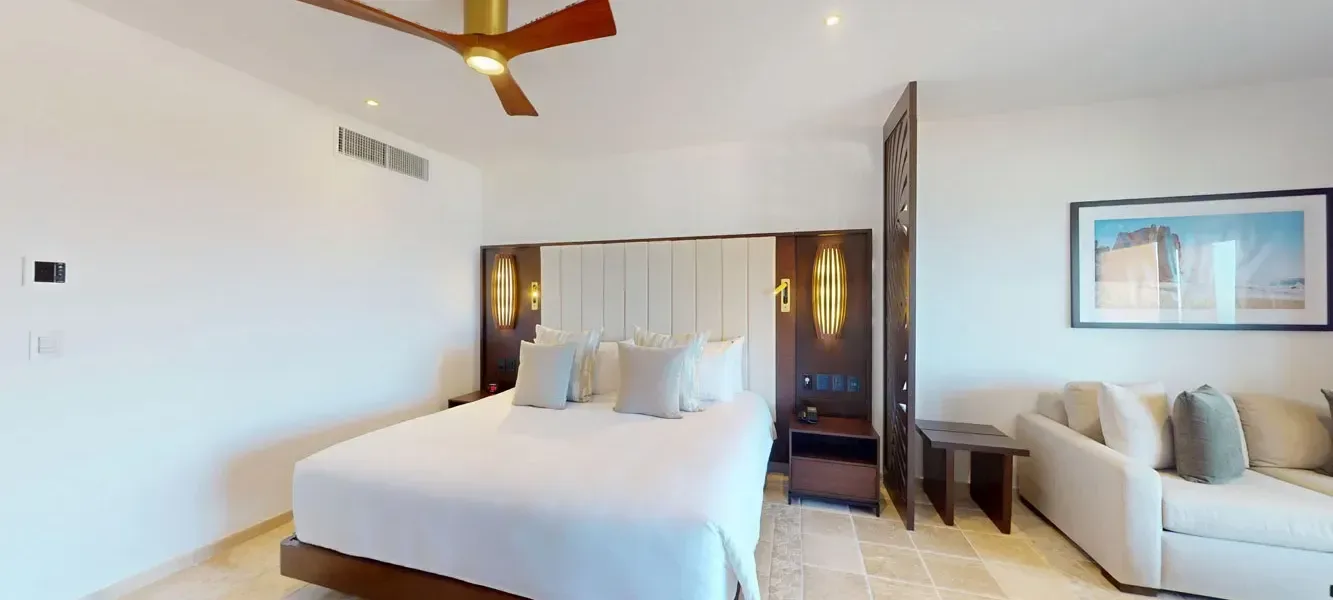 Deluxe Junior Suite king bed and sofa at Playa Grande Resort & Grand Spa.
