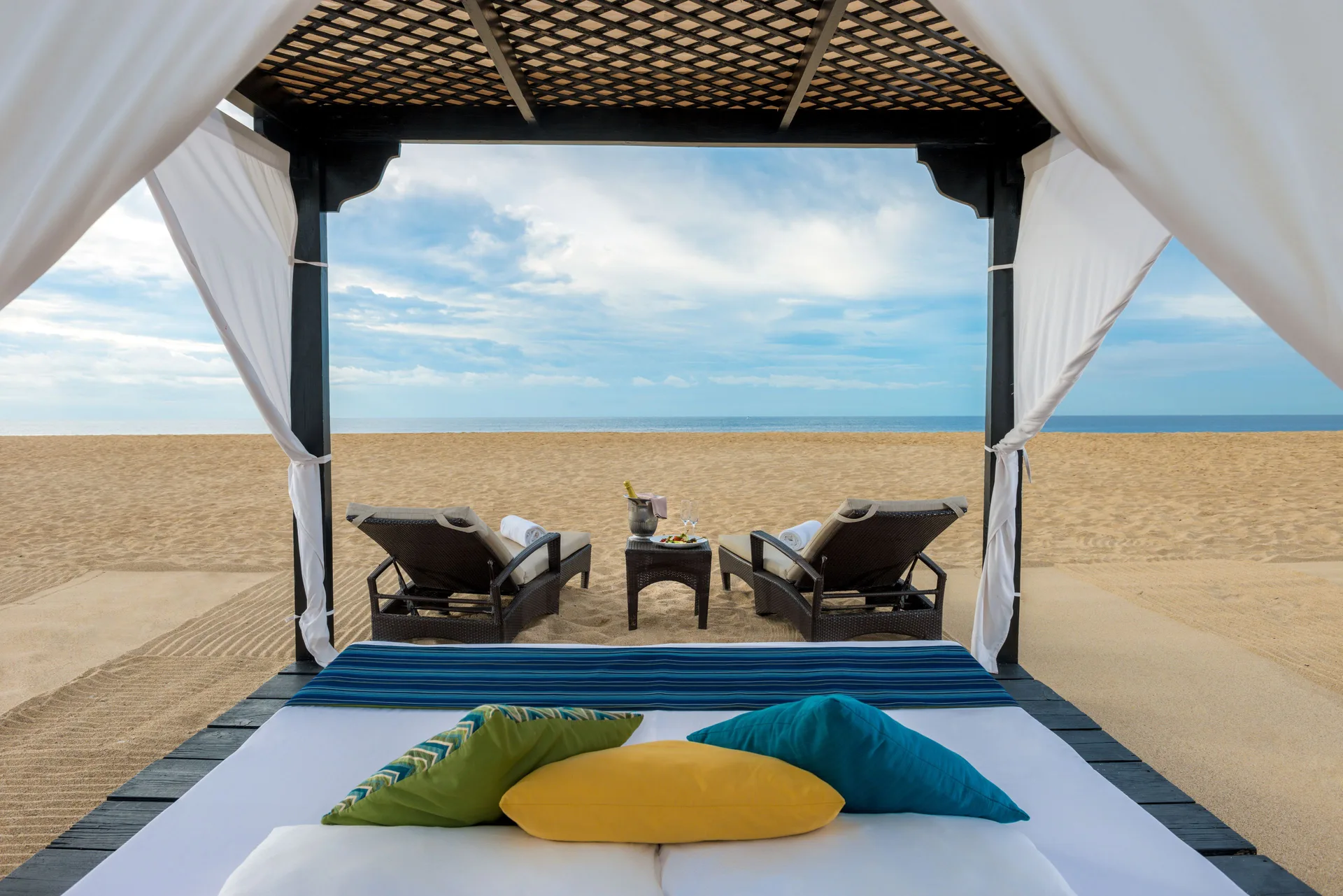 Beach cabana at Pueblo Bonito Pacifica Golf & Spa Resort with loungers facing the ocean.