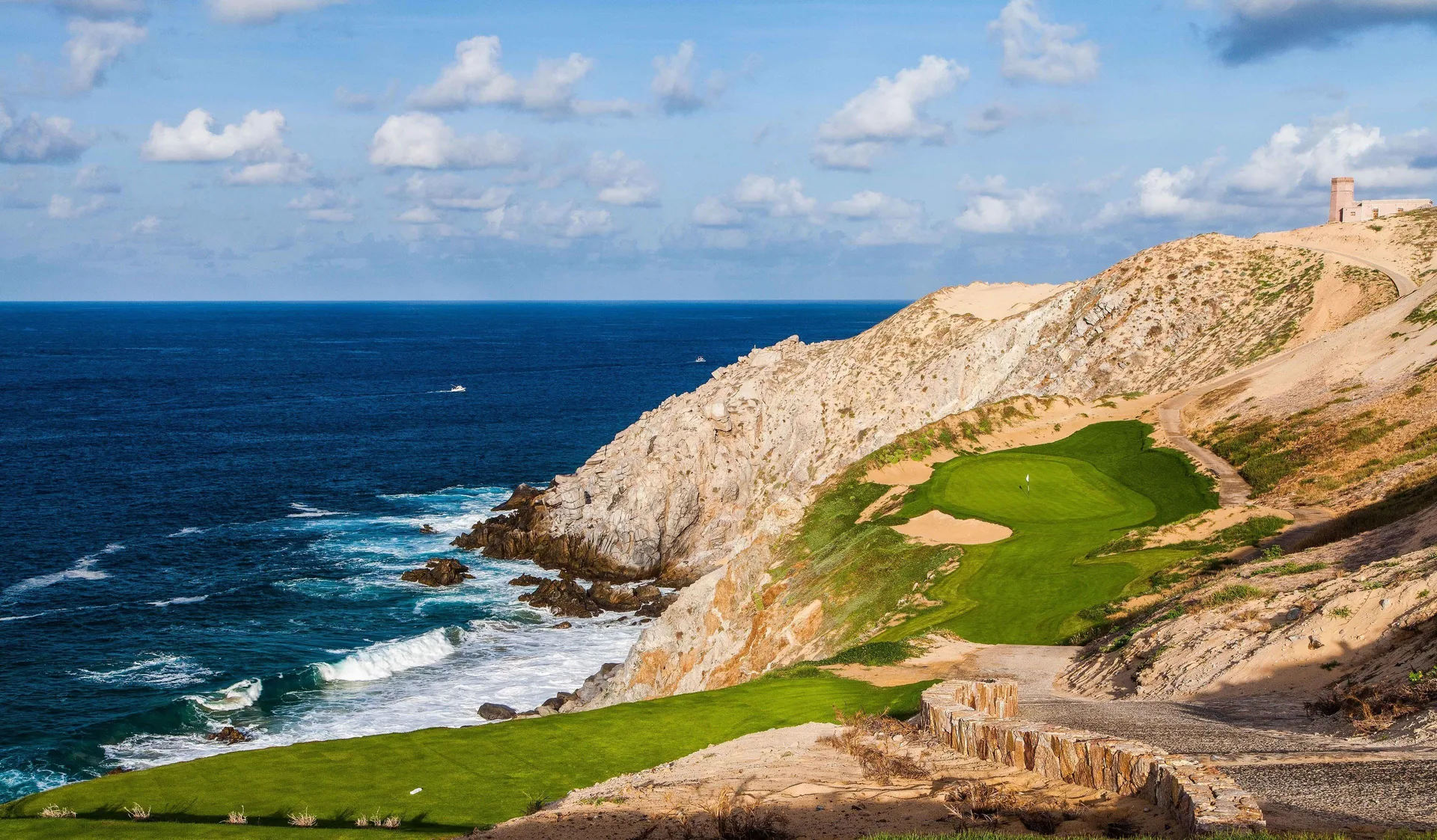 Clifftop golf green beside the ocean at Pueblo Bonito Pacifica Golf & Spa Resort.