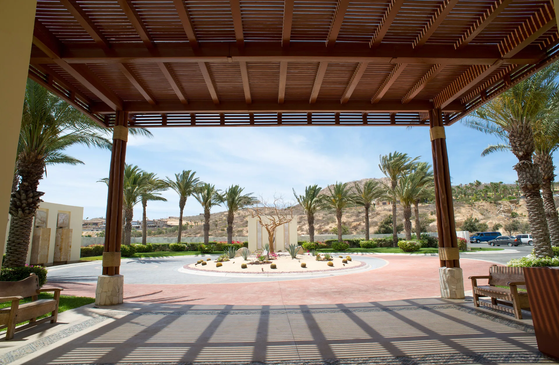 Covered arrival drive with palms and desert landscaping at Pueblo Bonito Pacifica Golf & Spa Resort.