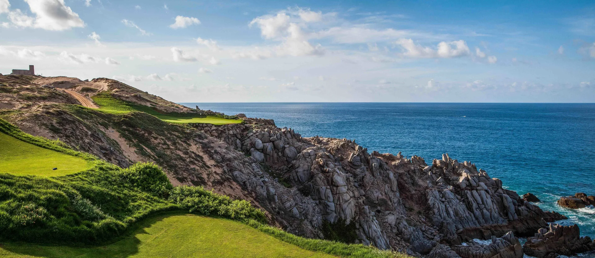 Oceanfront golf course along rocky cliffs at Pueblo Bonito Pacifica Golf & Spa Resort.