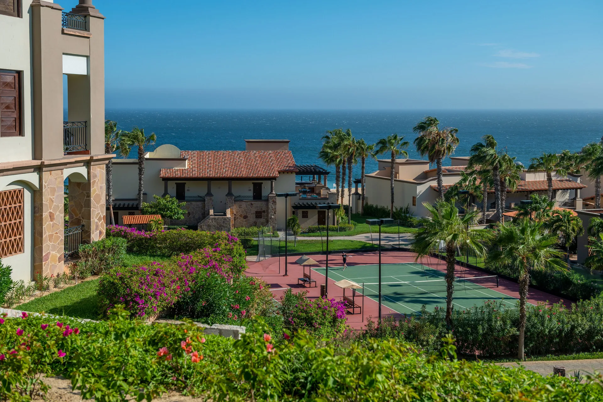 Resort gardens, tennis courts, and ocean at Pueblo Bonito Pacifica Golf & Spa Resort.