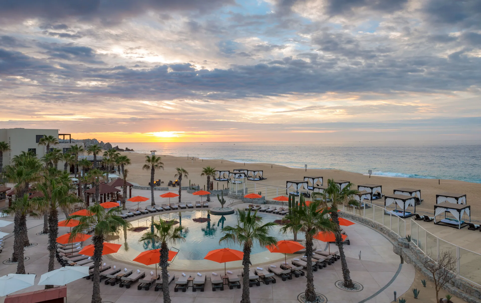 Sunset over the beachfront pool and cabanas at Pueblo Bonito Pacifica Golf & Spa Resort.