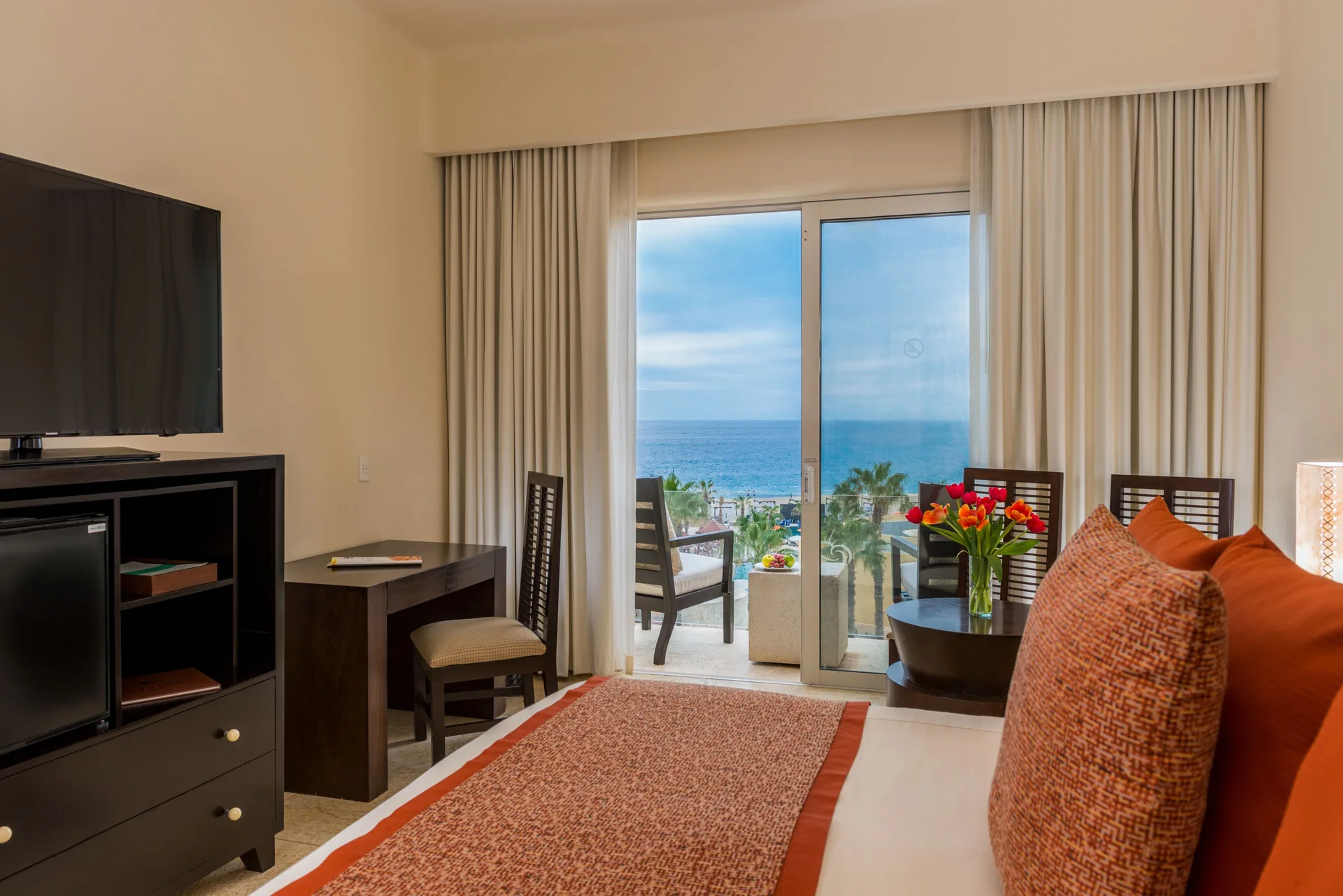 Deluxe Oceanview Room with king bed, desk, TV, and balcony at Pueblo Bonito Pacifica Golf & Spa Resort.