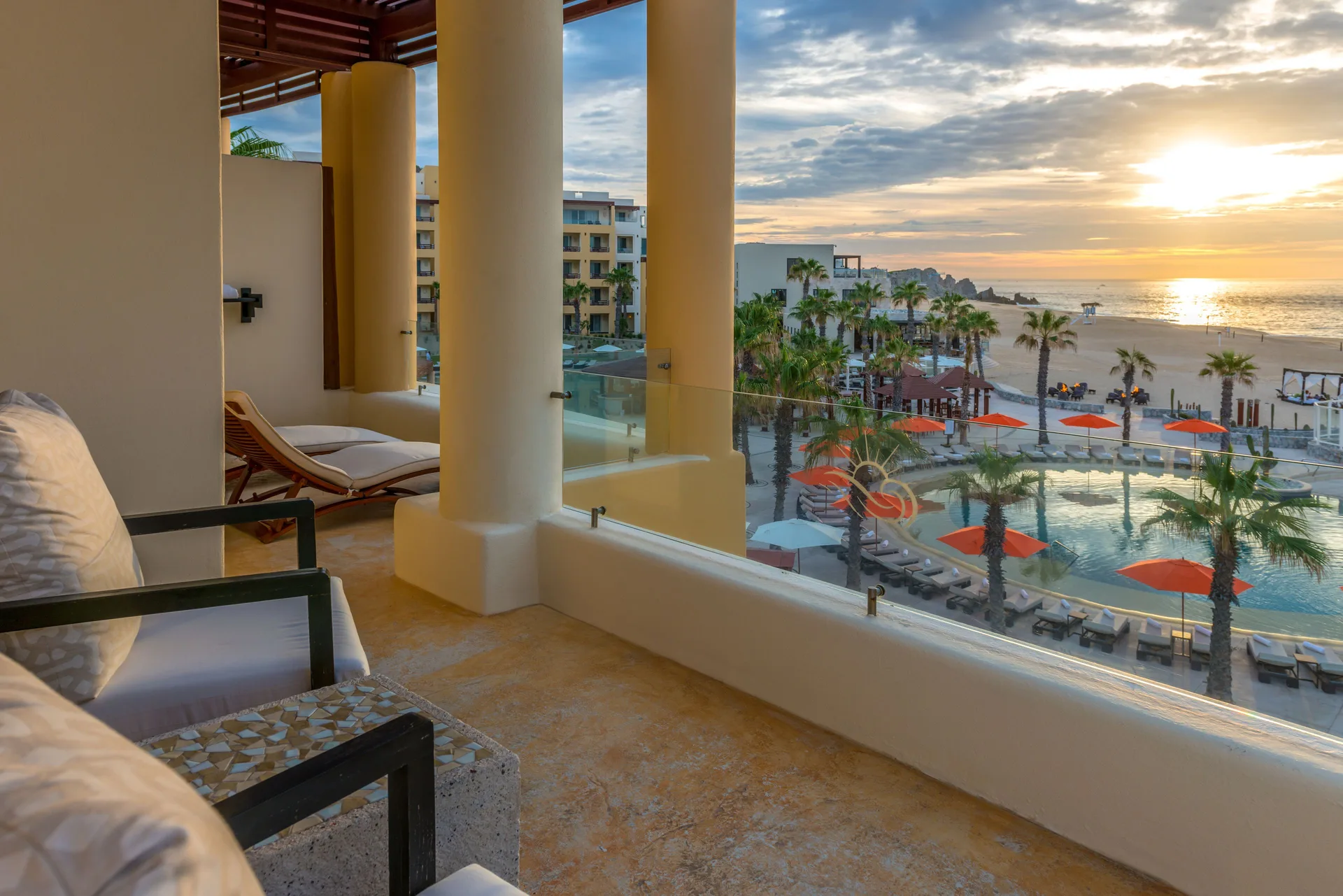 Towers Ocean View Suite balcony at Pueblo Bonito Pacifica Golf & Spa Resort overlooking pools and beach at sunset.