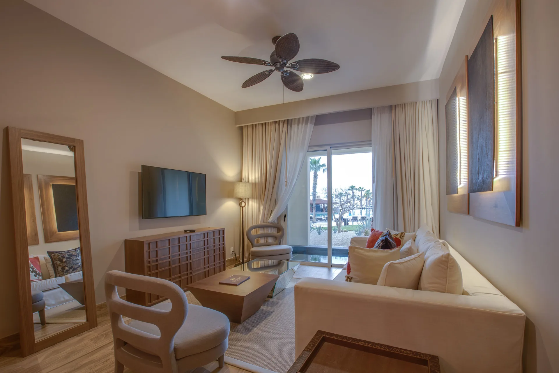 Towers Ocean View Suite living room at Pueblo Bonito Pacifica Golf & Spa Resort with sofa and balcony doors.