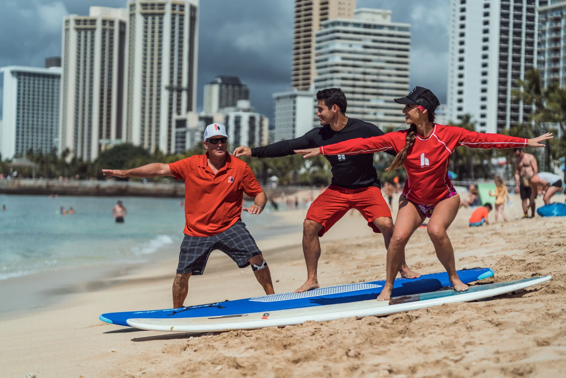 A surf lesson takes place on the sand near Queen Kapiolani Hotel.