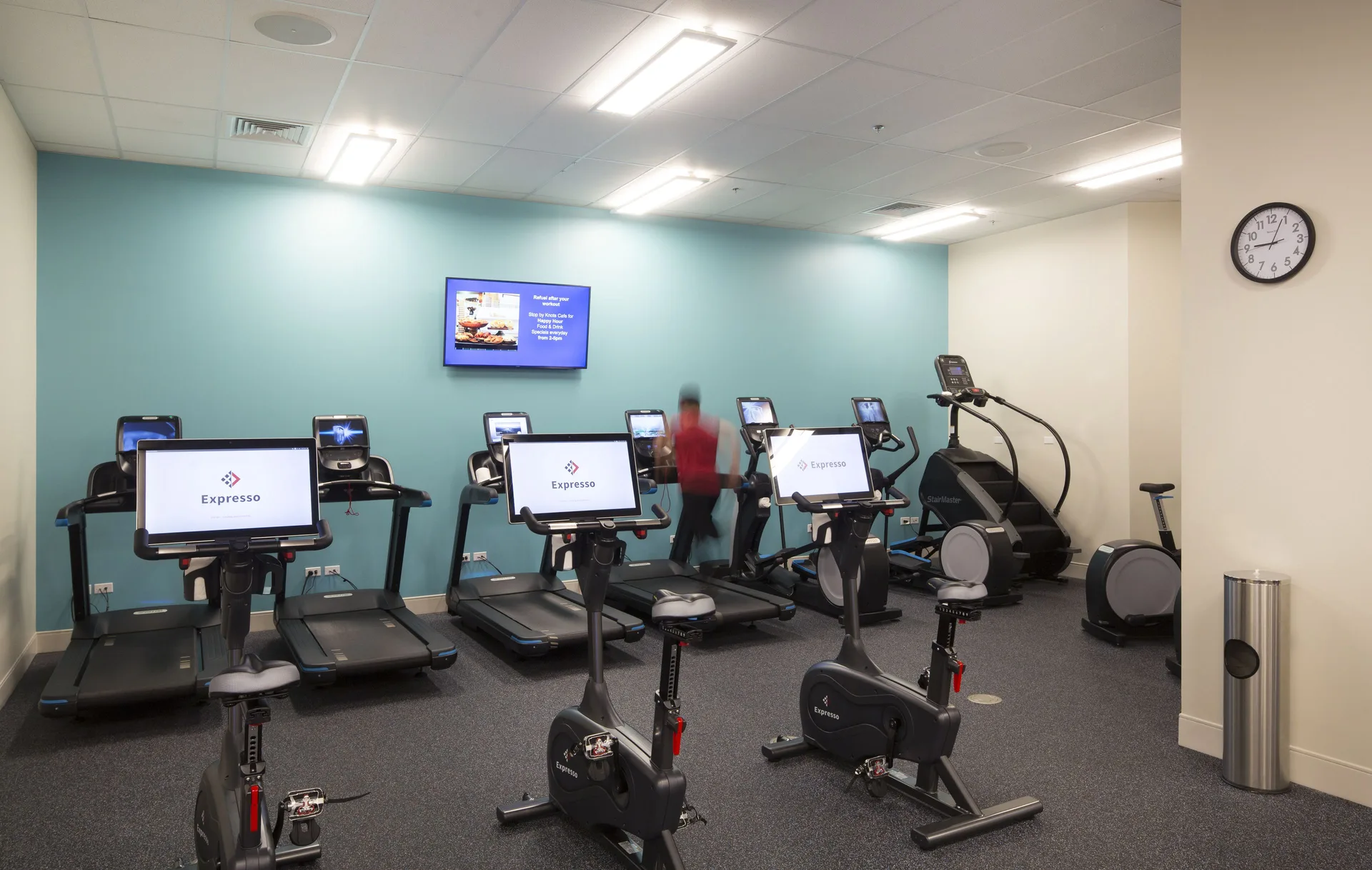Treadmills and exercise bikes line the fitness center at Queen Kapiolani Hotel.