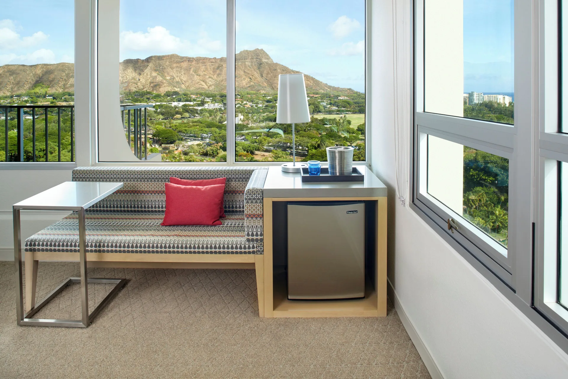 Window sitting area with Diamond Head view at Queen Kapiolani Hotel.