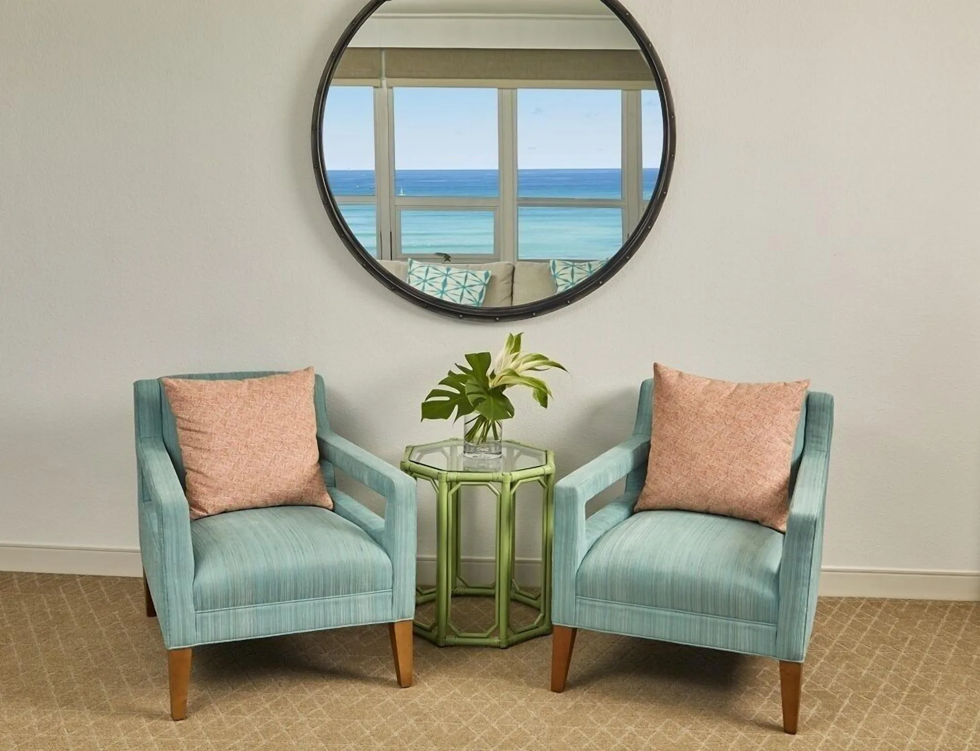 Penthouse suite chairs and ocean reflection at Queen Kapiolani Hotel.