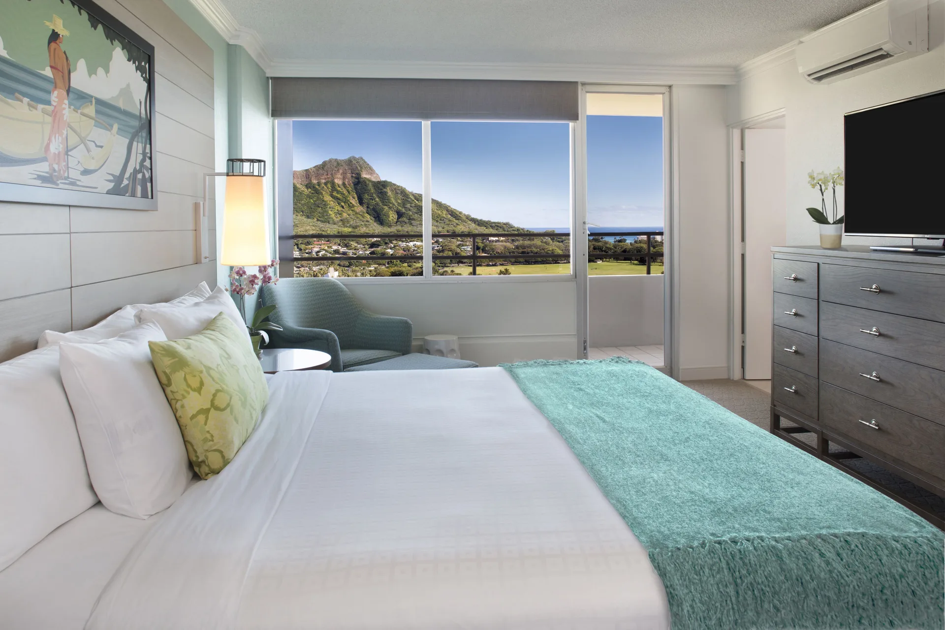 Penthouse ocean view bedroom with balcony at Queen Kapiolani Hotel.
