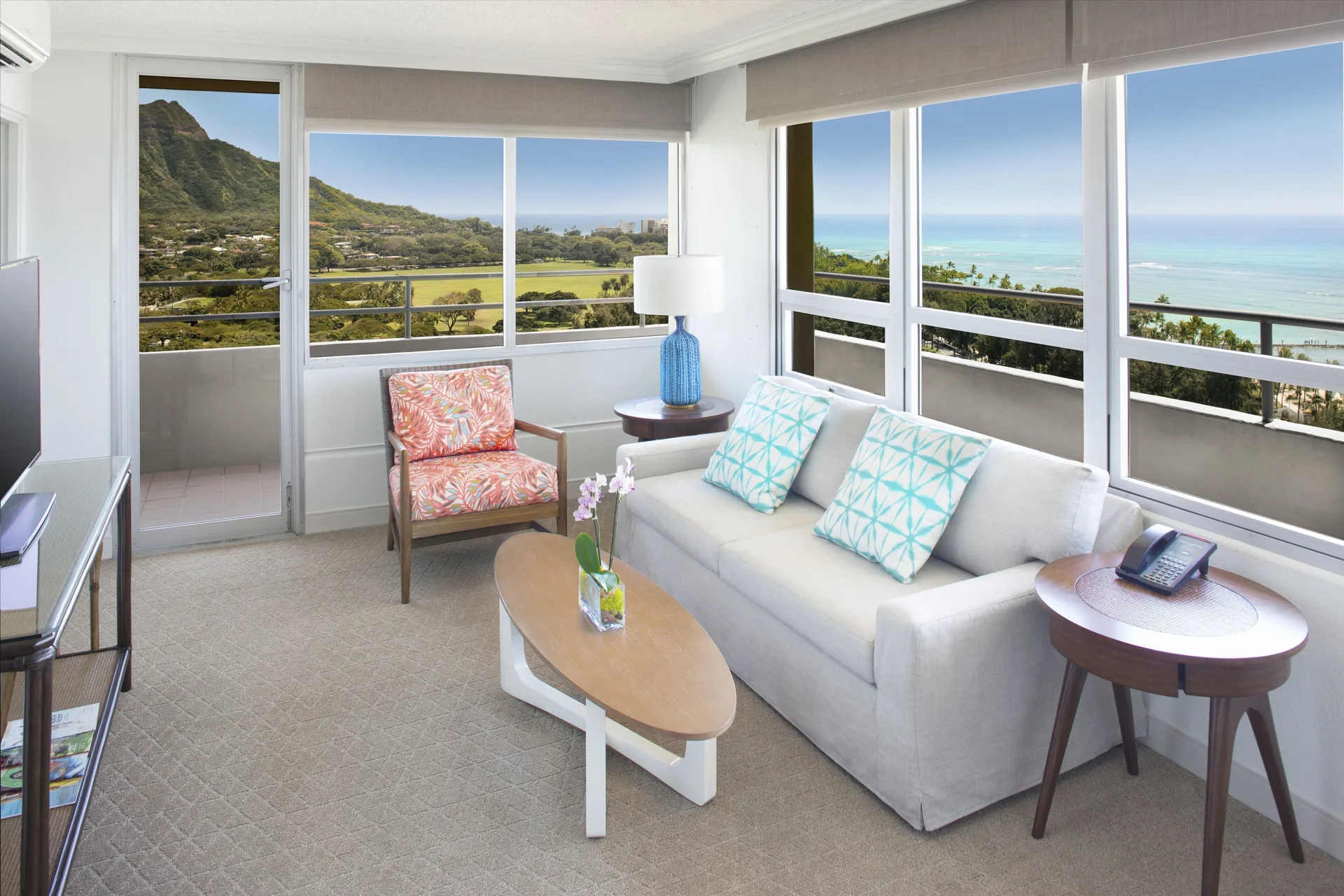 Penthouse ocean view suite living room and balcony at Queen Kapiolani Hotel.