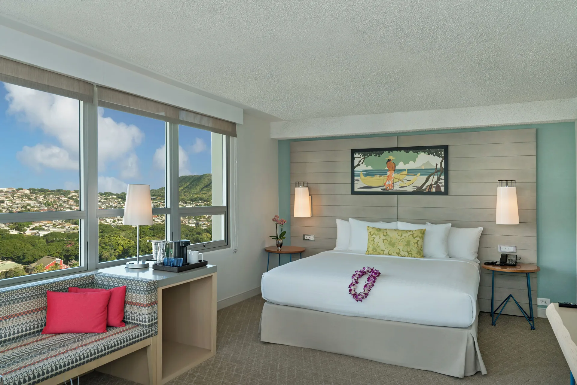 King bed city view room with large windows at Queen Kapiolani Hotel.