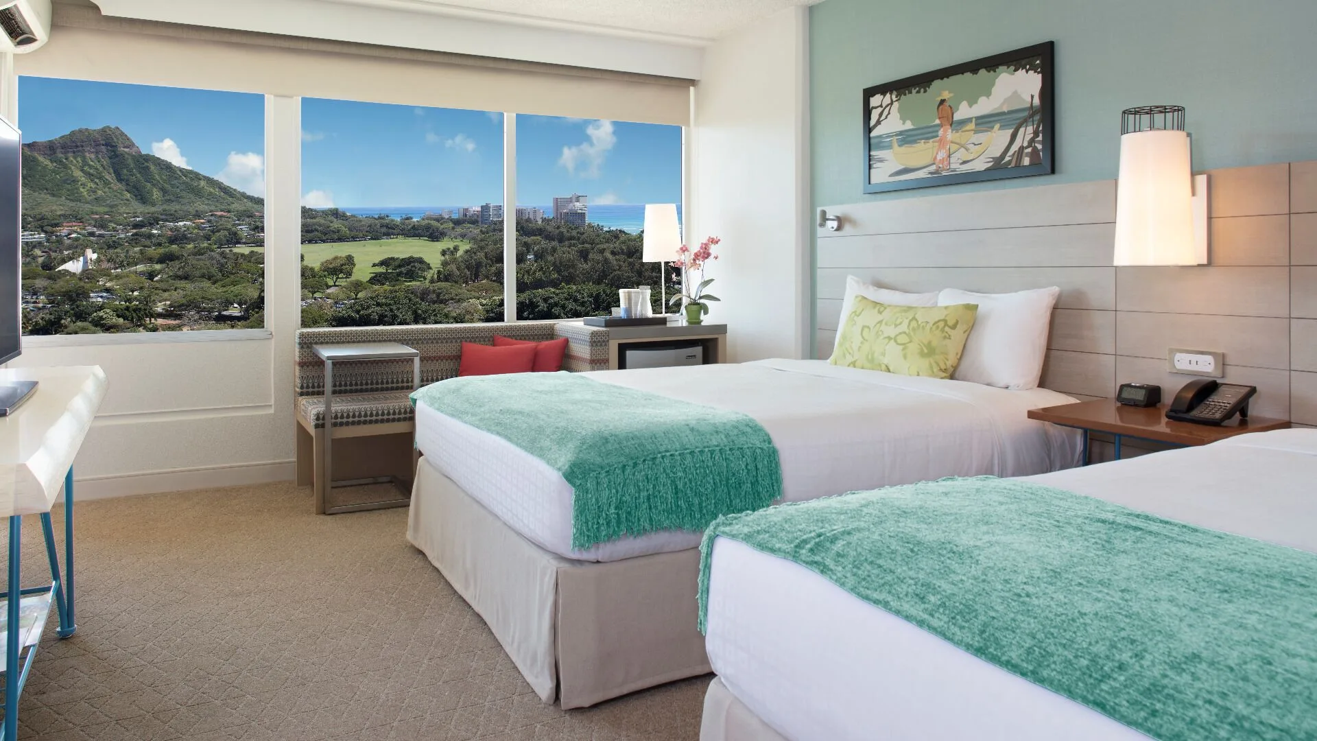 Two-bed Diamond Head view guest room at Queen Kapiolani Hotel with large windows and sitting area.