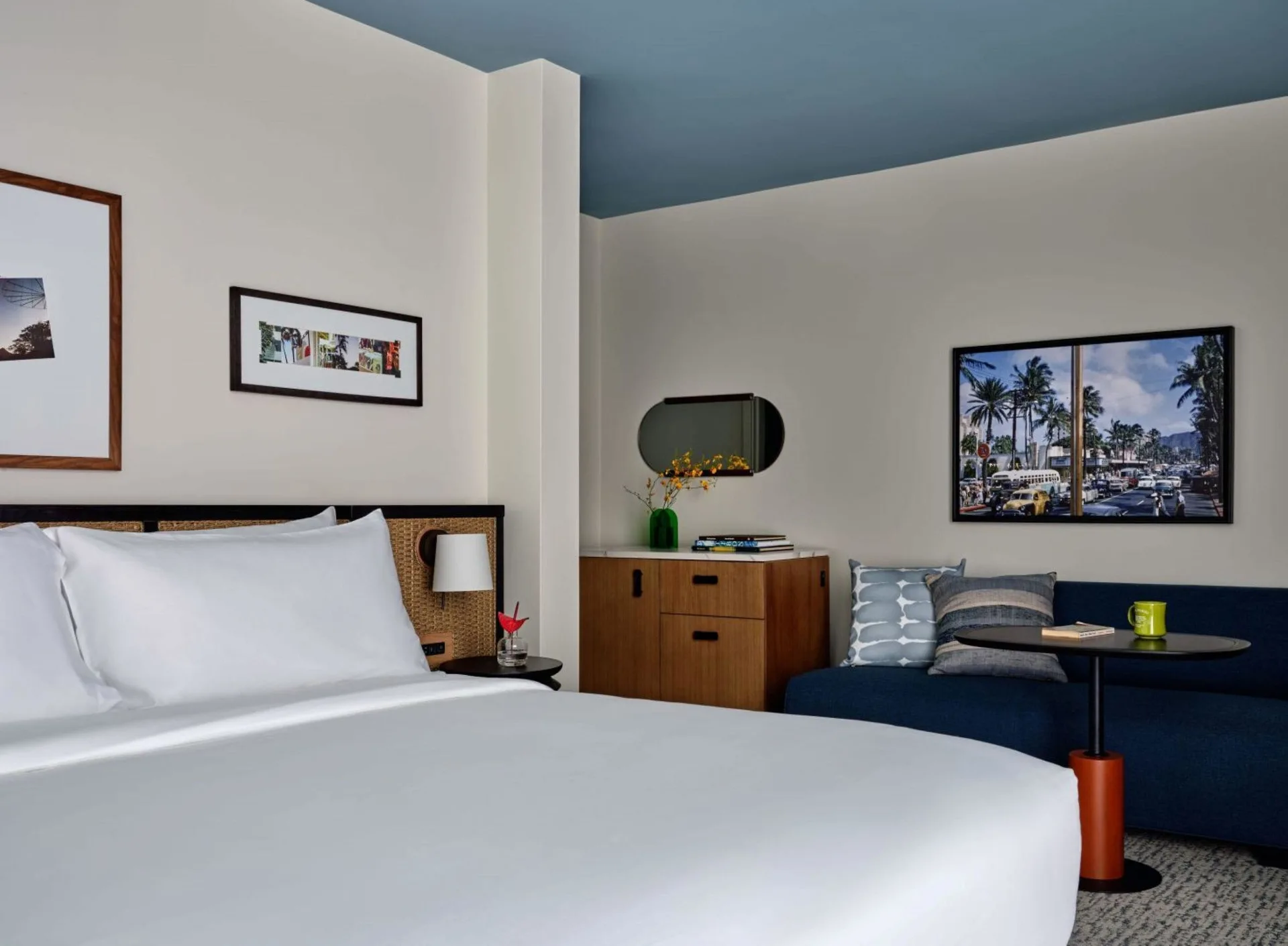 King bed, blue daybed, dresser and wall art in a Premium Room Balcony at Romer House Waikiki.