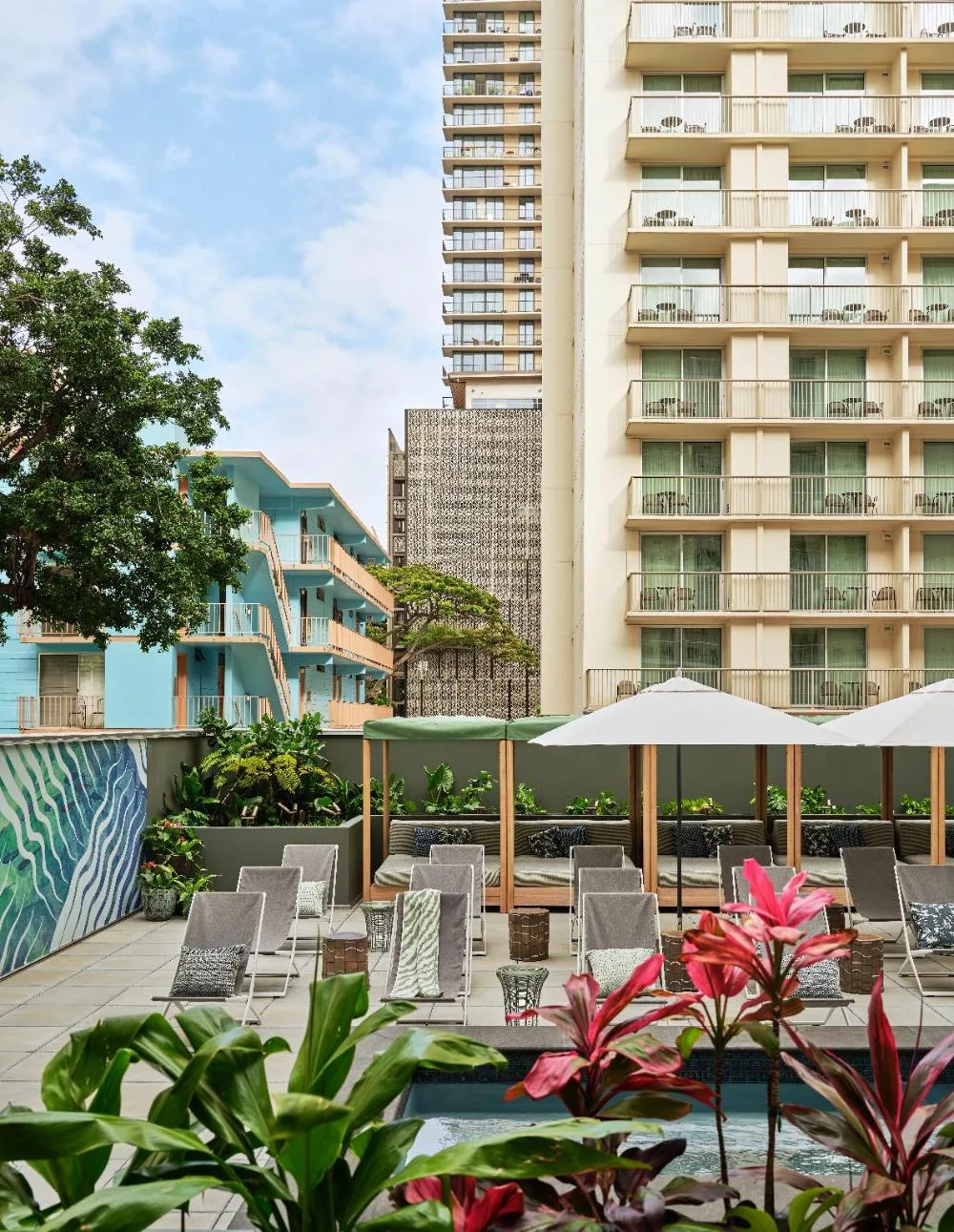 View from a Standard Room toward the pool deck and nearby balconies at Romer House Waikiki.