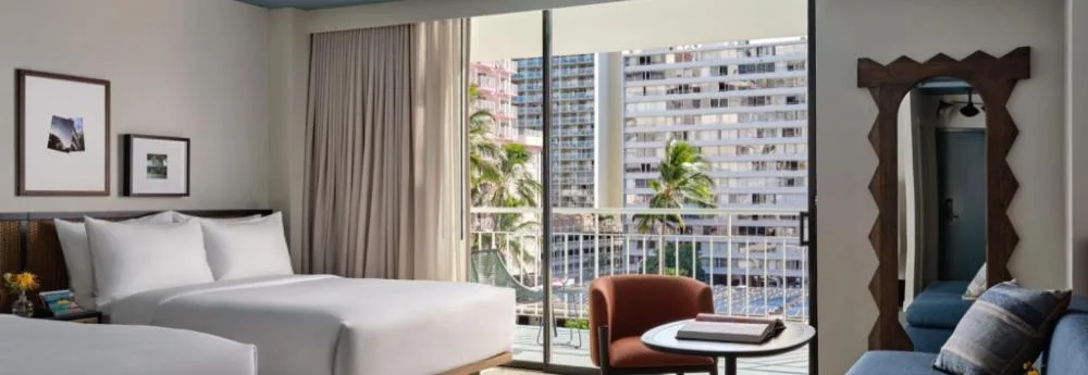 Two Bedroom Suite with Balcony and Sofa Bed at Romer House Waikiki with bed, sitting area and city-facing balcony.