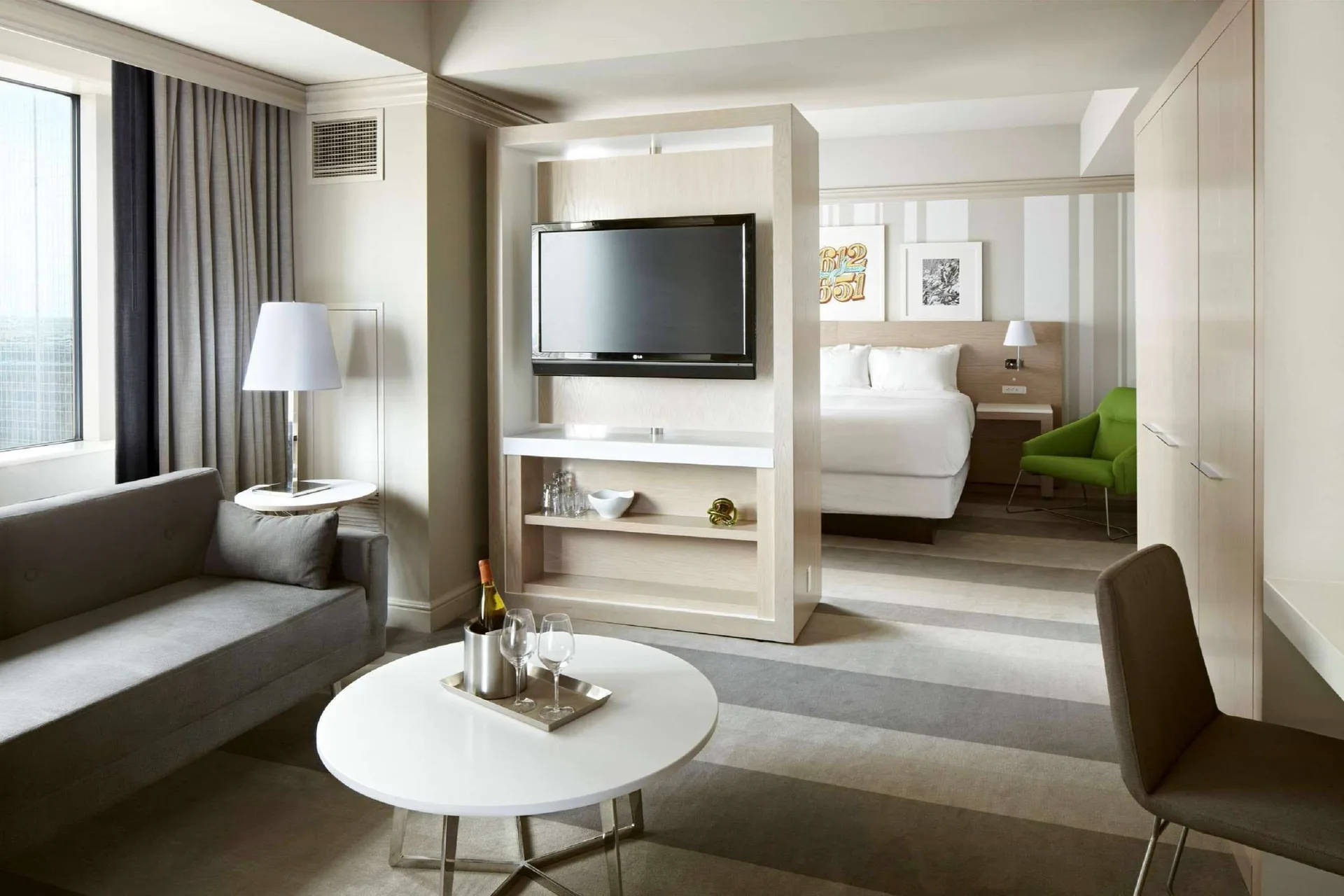 Superior Suite Business Class king bed and living area at Royal Sonesta Minneapolis Downtown with enhanced workspace, modern design, and downtown Minneapolis business amenities.