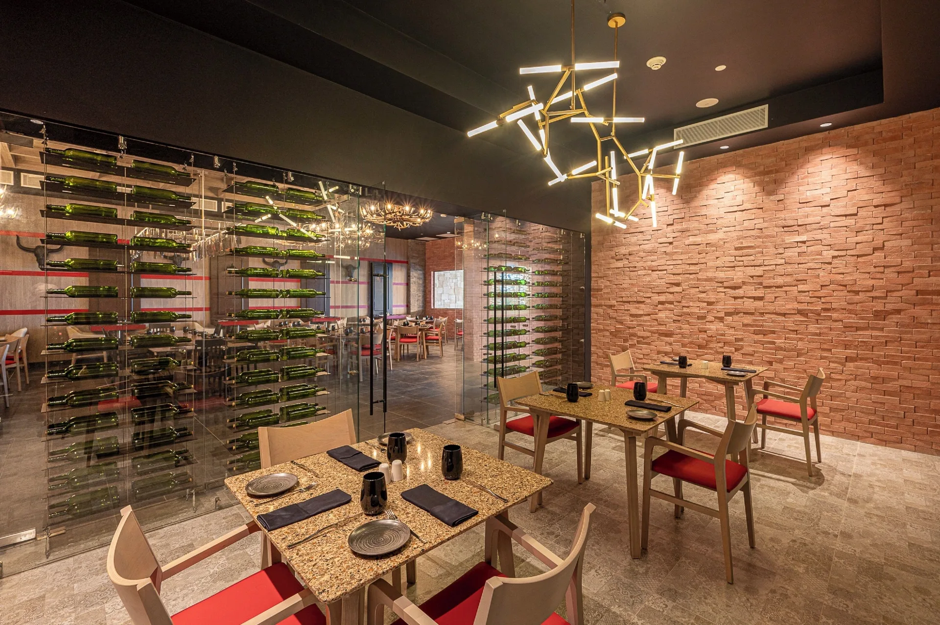 Wine display and set tables in a restaurant dining room at Royalton CHIC Antigua.