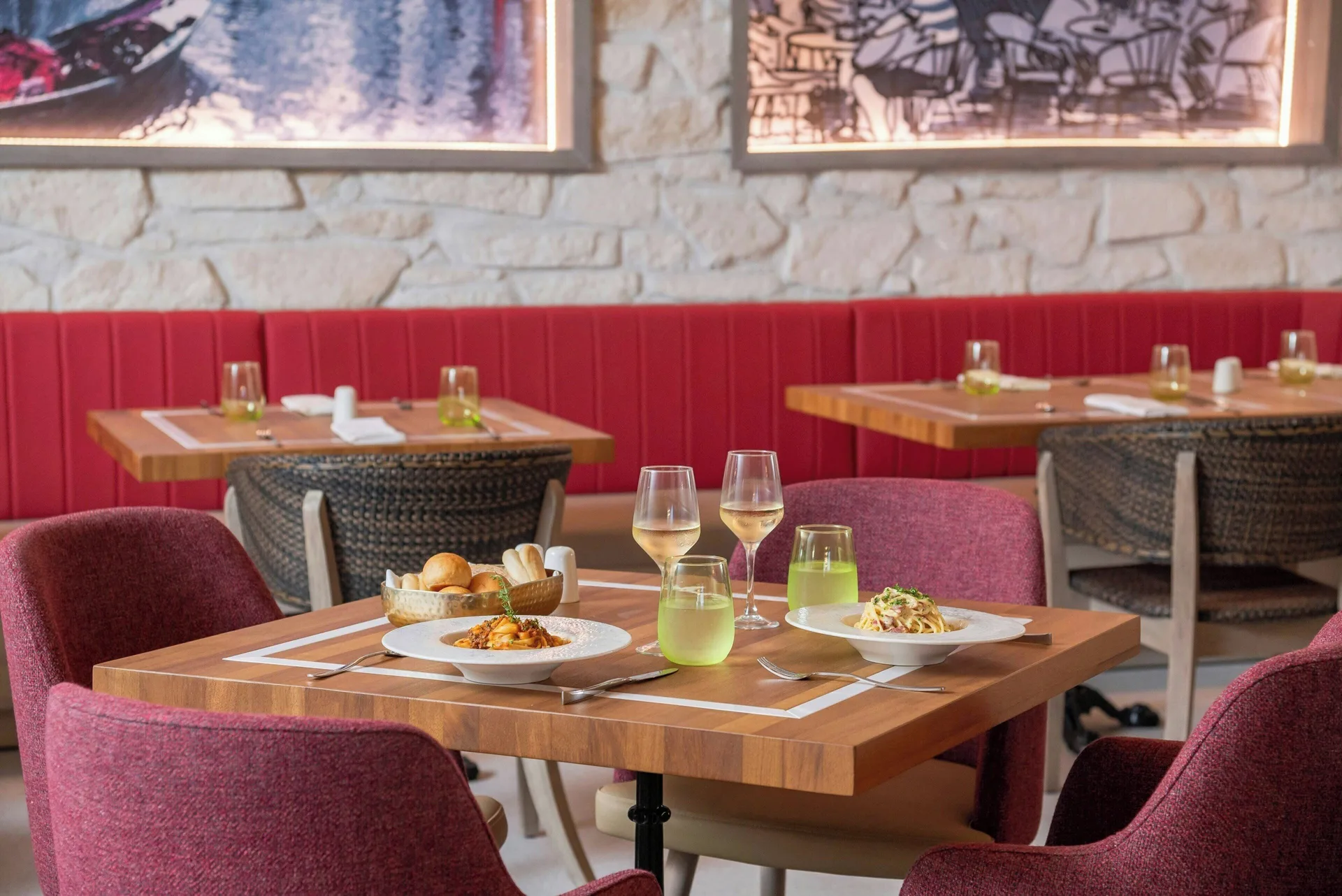 Italian-style restaurant table with pasta and wine at Royalton CHIC Antigua.