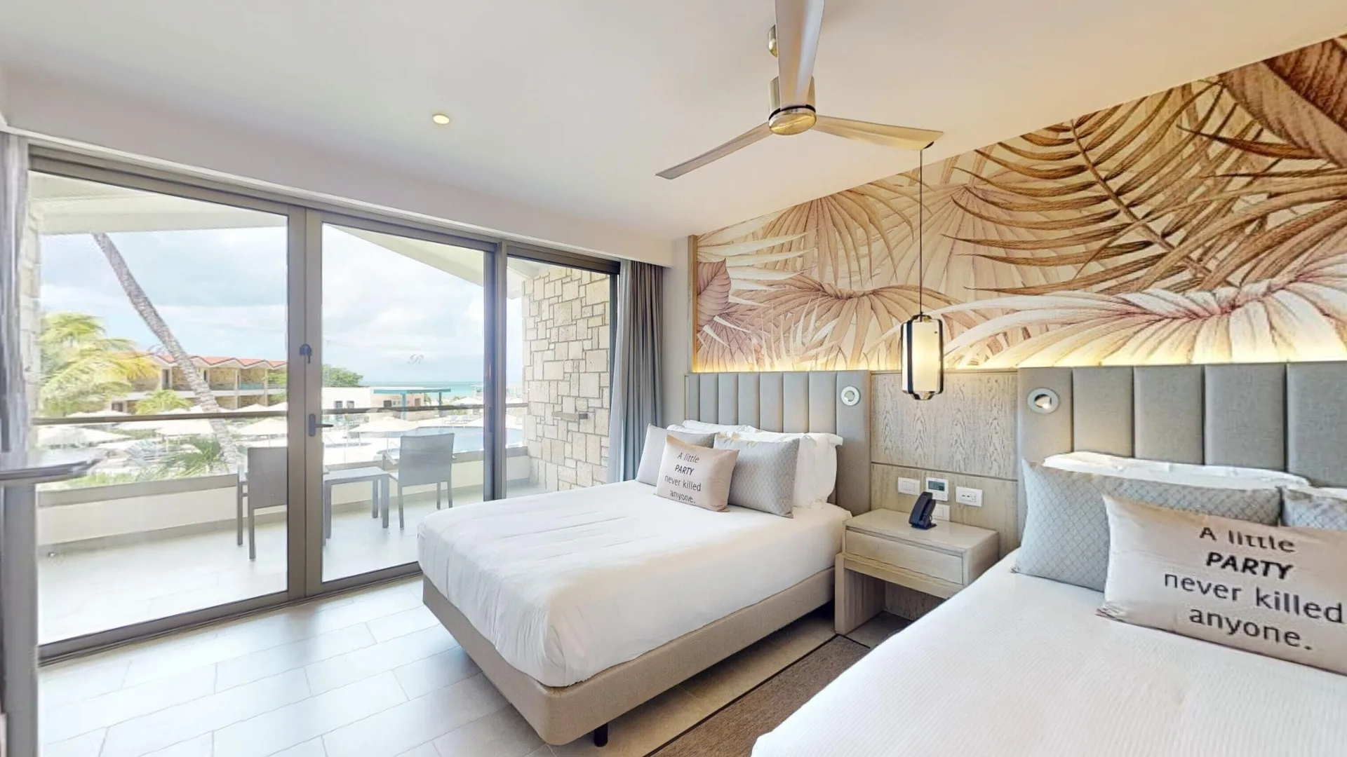 Two queen beds and balcony in a Luxury Garden View Room Diamond Club at Royalton CHIC Antigua.