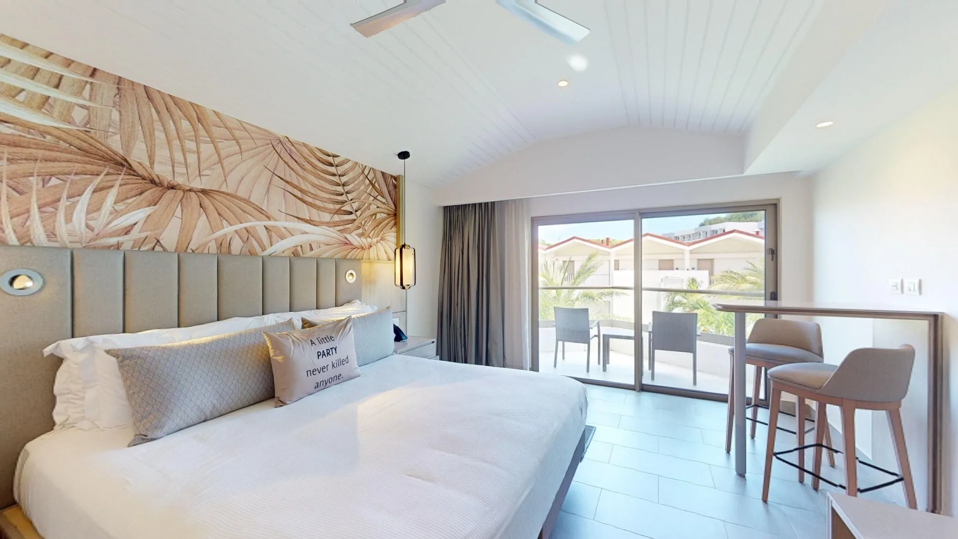 Luxury Garden View Room king bed with balcony seating at Royalton CHIC Antigua.
