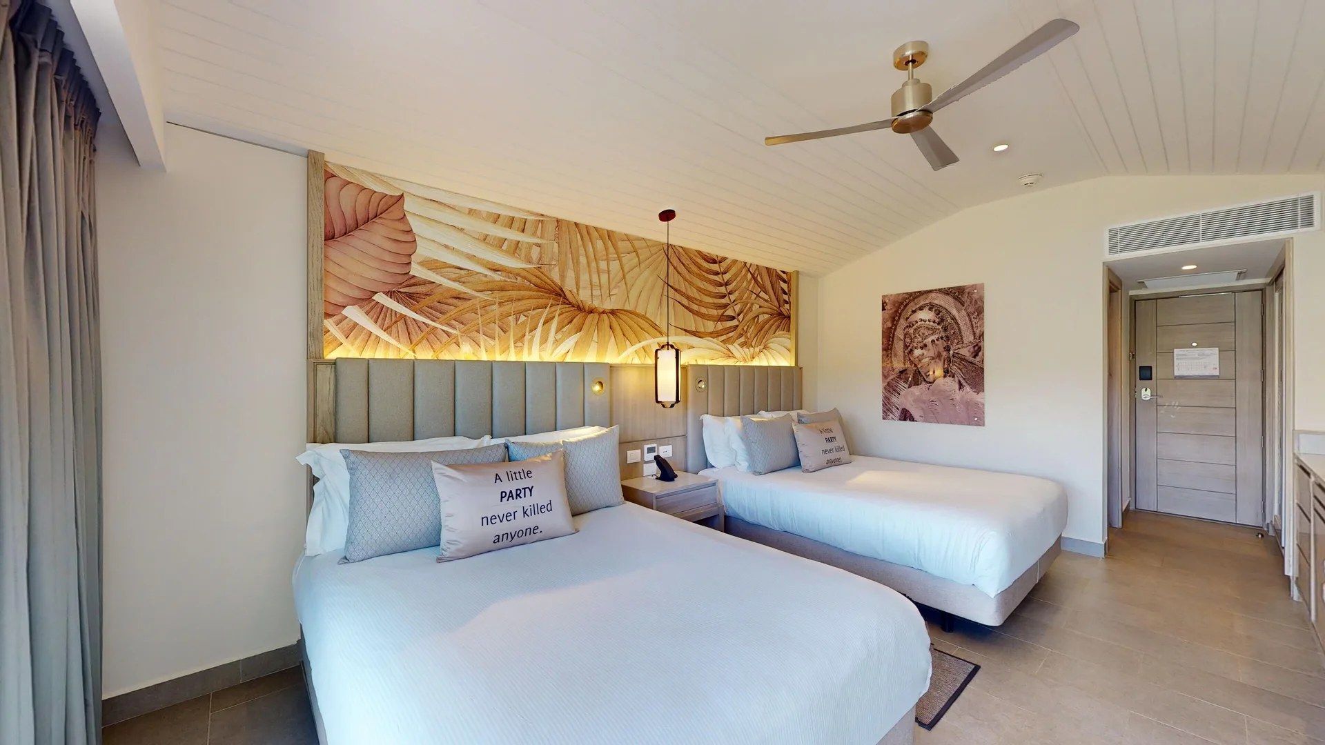 Luxury Garden View Room with two beds and tropical wall art at Royalton CHIC Antigua.