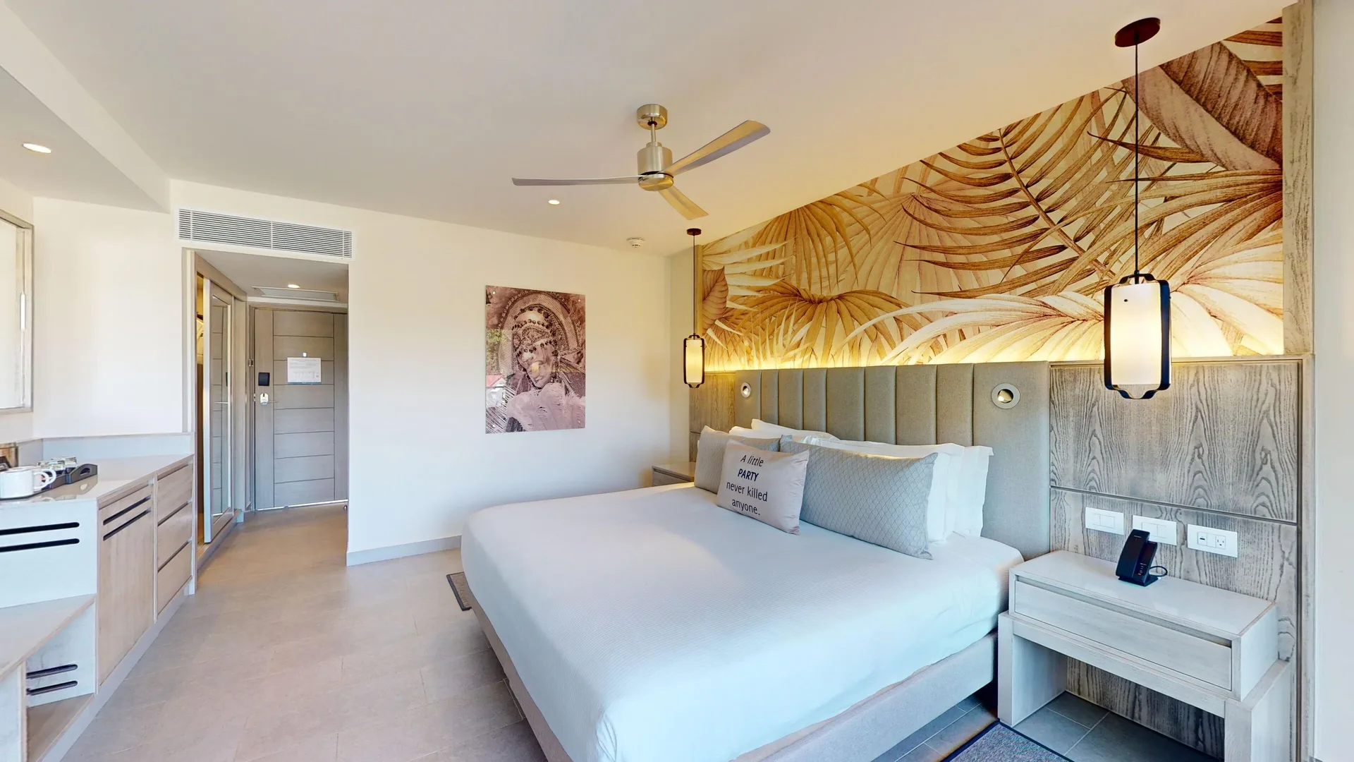 Luxury Ocean View Room king bed with leaf mural at Royalton CHIC Antigua.