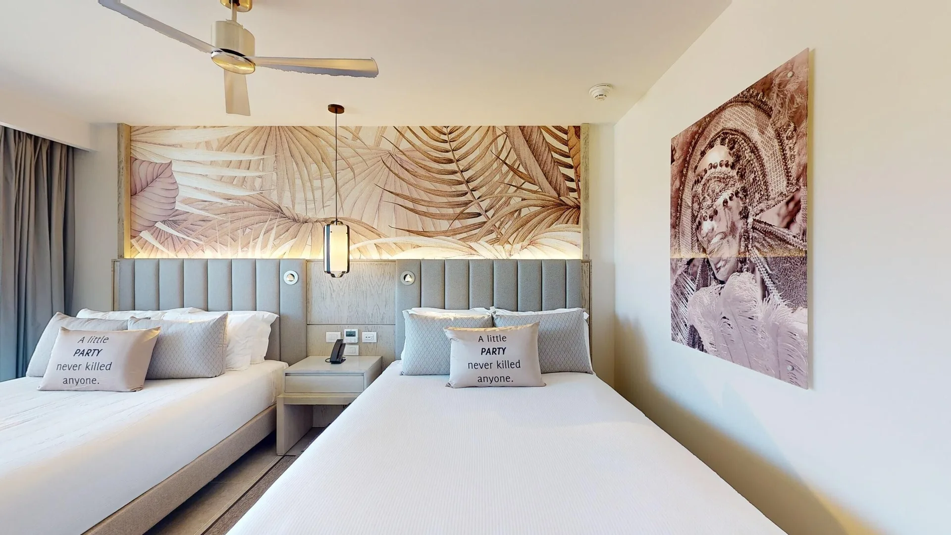 Luxury Ocean View Room with two beds and tropical wall art at Royalton CHIC Antigua.