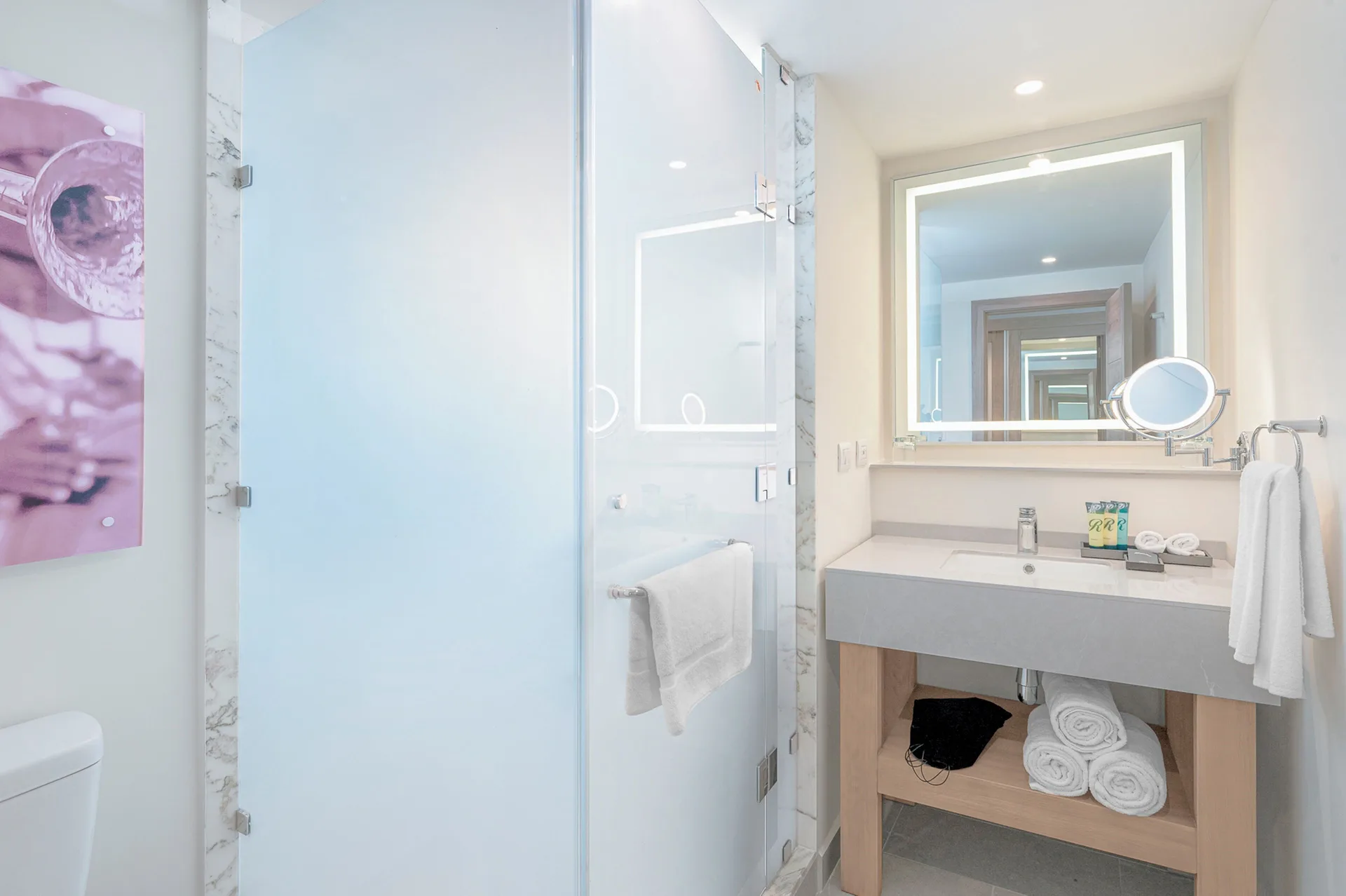 Luxury Pool View Room bathroom with glass shower and vanity at Royalton CHIC Antigua.