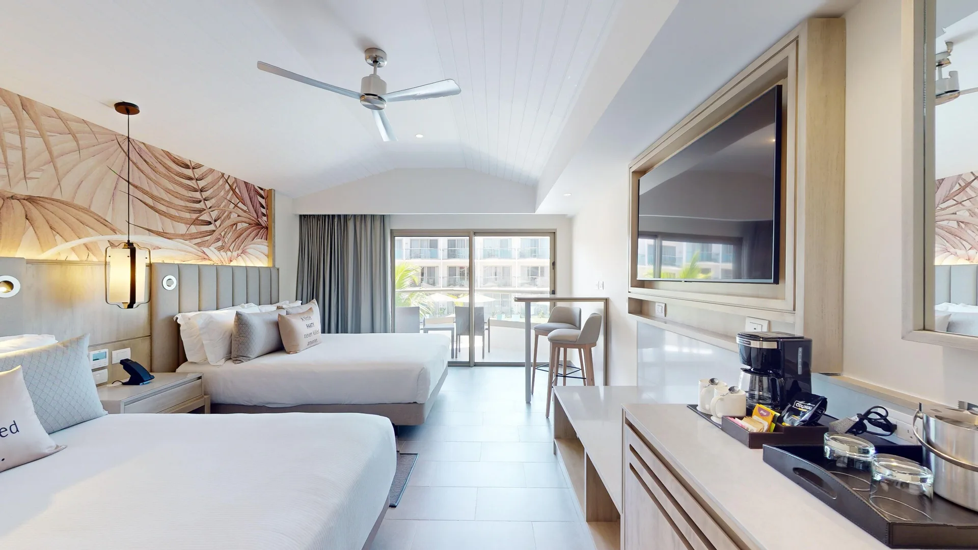 Luxury Pool View Room with two beds, TV, and balcony doors at Royalton CHIC Antigua.