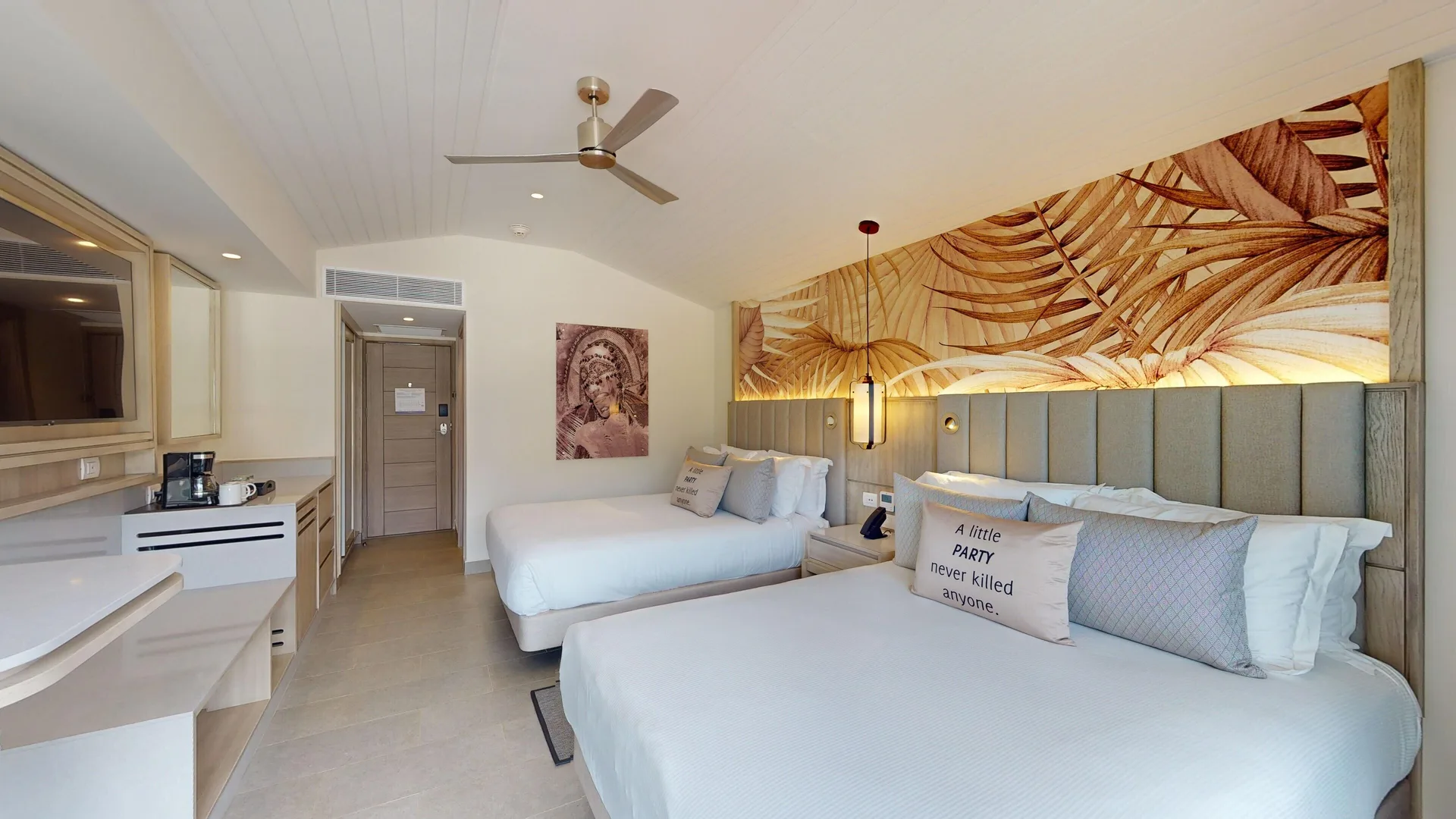 Luxury Pool View Room with two beds and tropical wall art at Royalton CHIC Antigua.