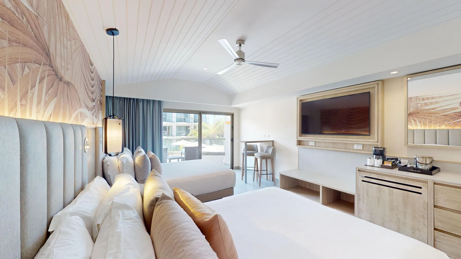 Luxury Pool View Room with two beds, TV wall, and balcony light at Royalton CHIC Antigua.
