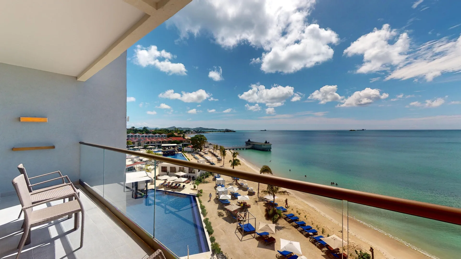 Suite balcony overlooking the beach and sea at Royalton CHIC Antigua.