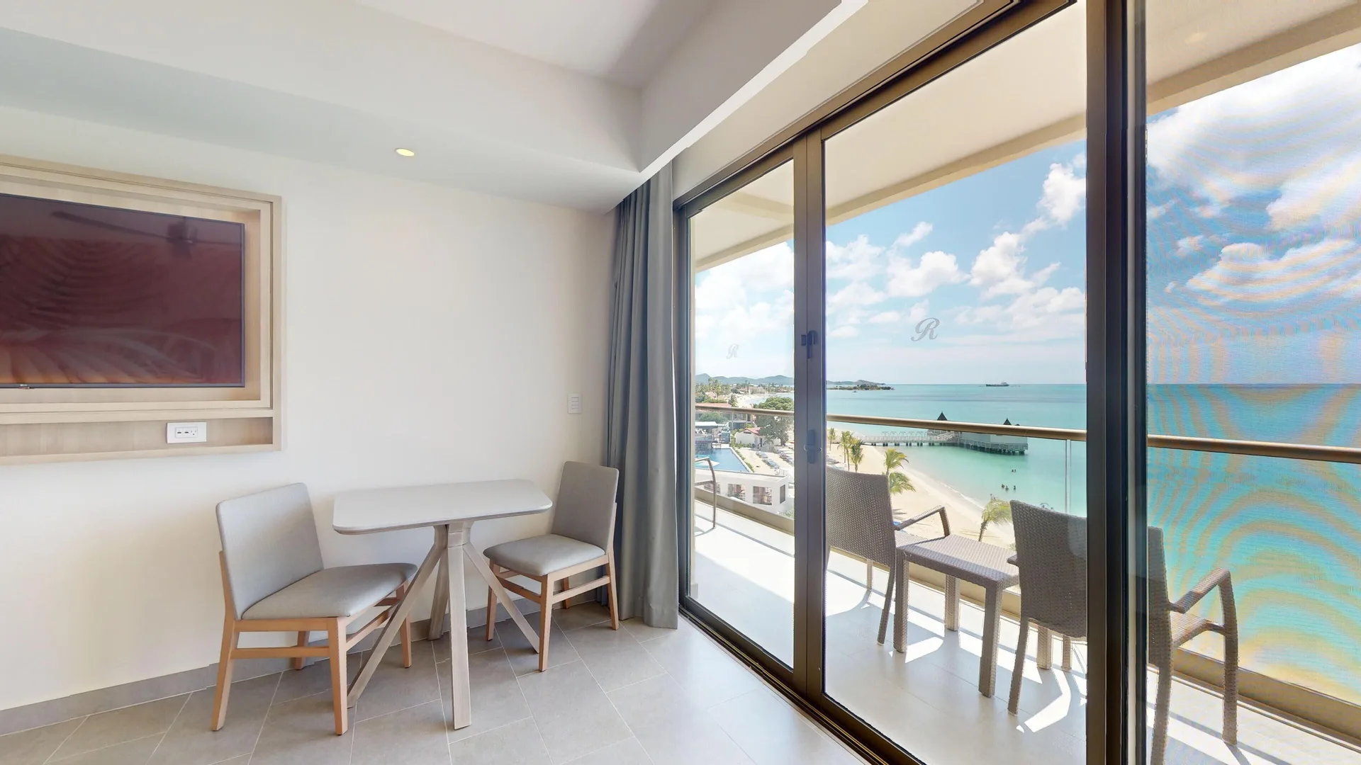 Dining nook and balcony ocean view in a suite at Royalton CHIC Antigua.