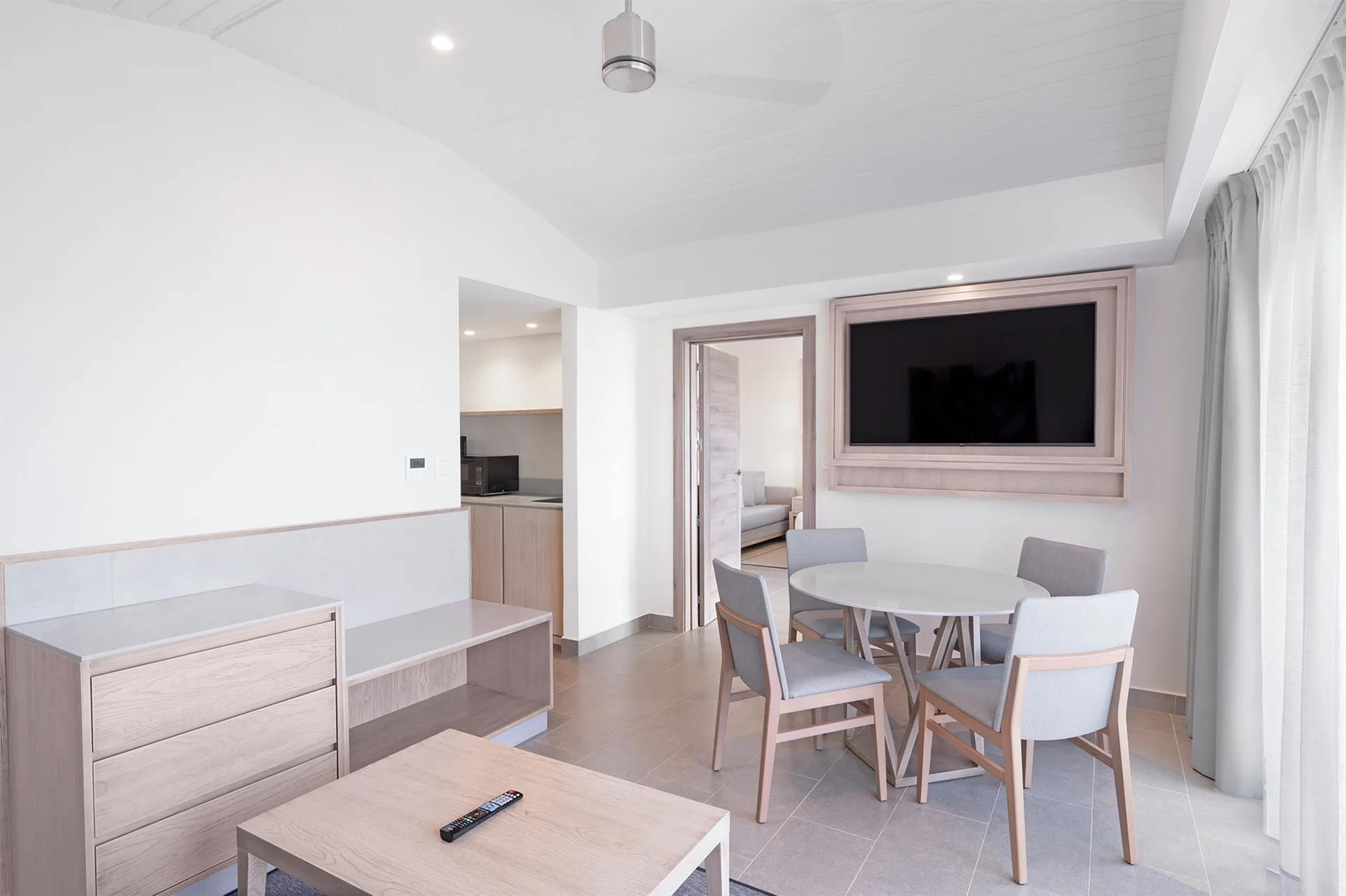 Suite living and dining area with TV at Royalton CHIC Antigua.