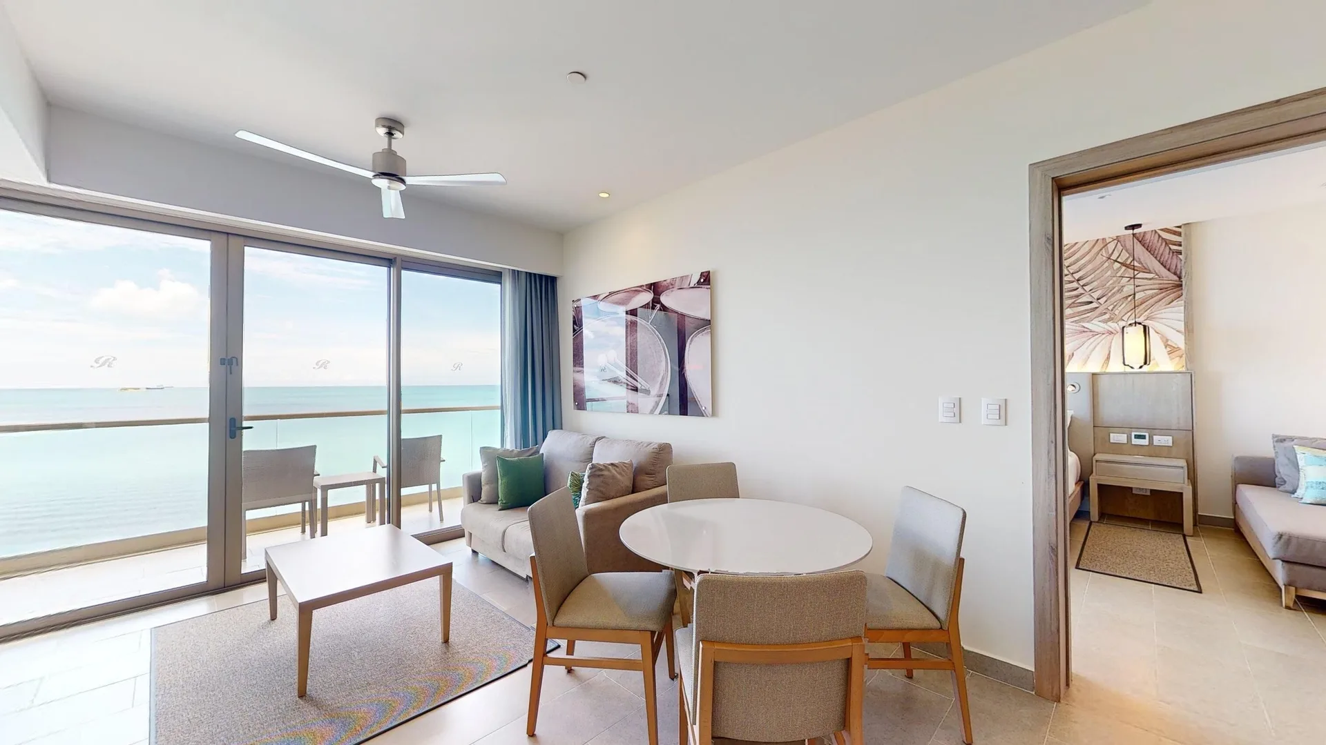 Living and dining room with balcony sea view at Royalton CHIC Antigua.