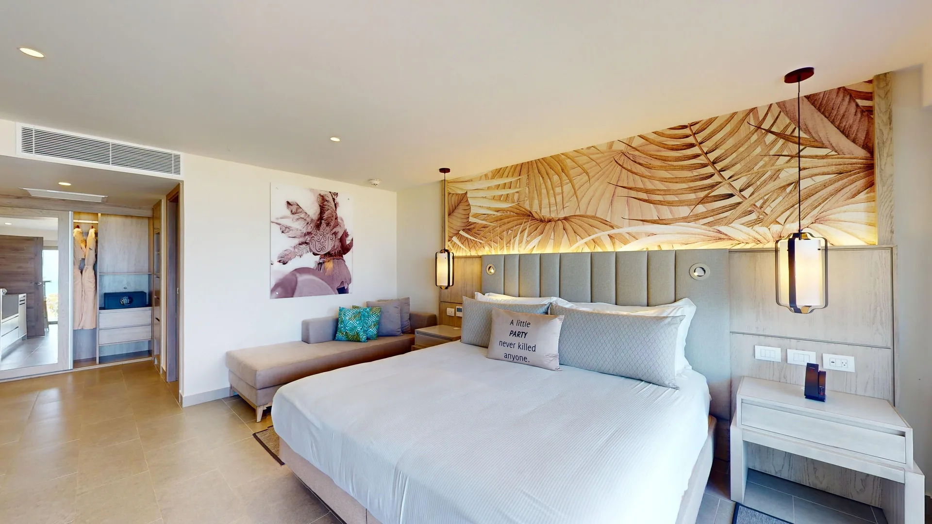 Presidential beachfront suite king bed, chaise, and wardrobe at Royalton CHIC Antigua.