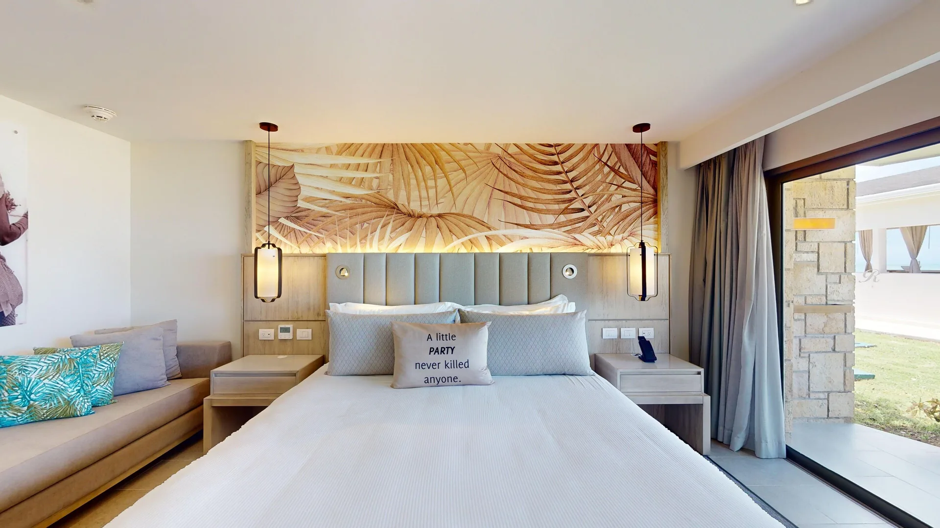 Presidential beachfront suite king bed and sofa at Royalton CHIC Antigua.