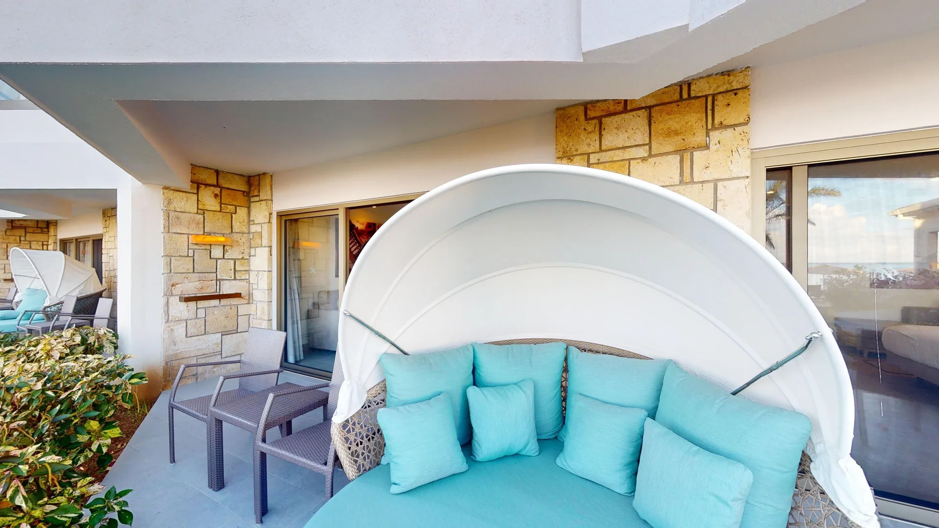 Walkout terrace daybed and chairs for a suite at Royalton CHIC Antigua.