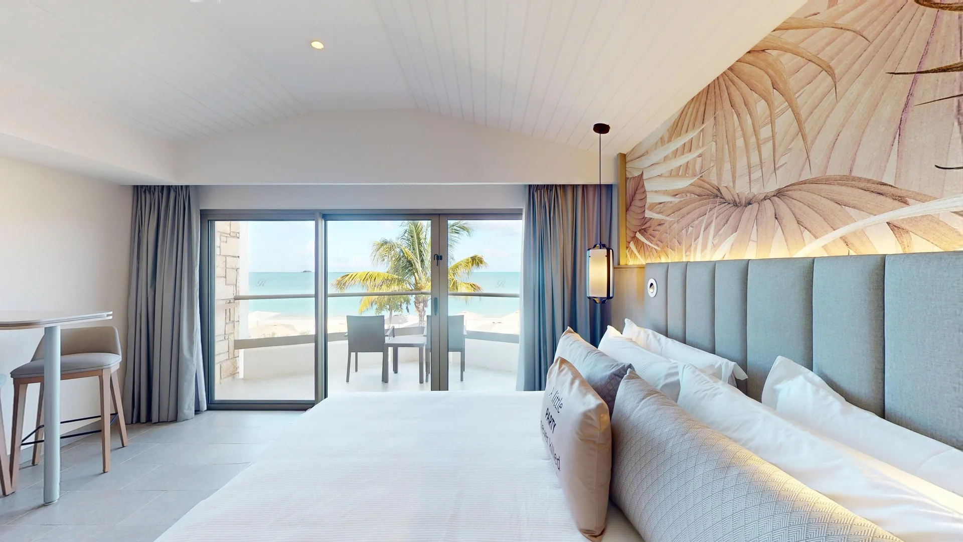 Oceanfront one-bedroom suite with king bed and balcony at Royalton CHIC Antigua.